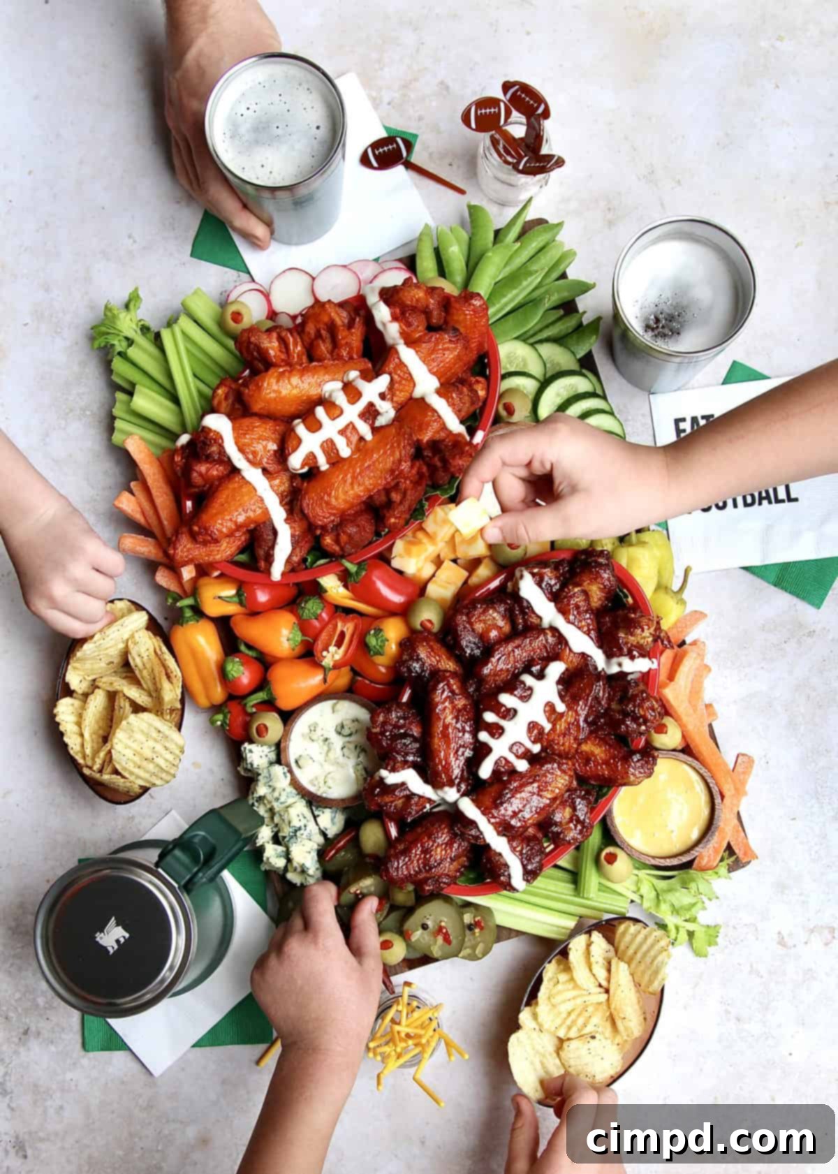 Ultimate Wing Spread 2 A vibrant Chicken Wings Snack Board featuring buffalo and BBQ wings, fresh vegetables, and dipping sauces.