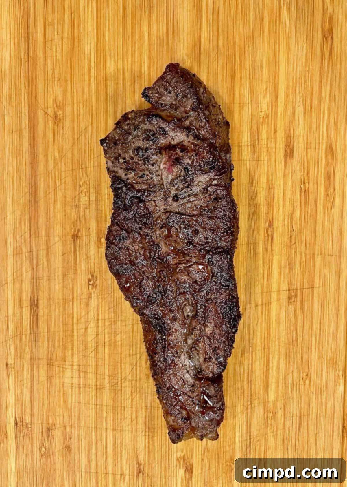 How to Reverse Sear a Steak: uncooked steak seasoned with salt and pepper