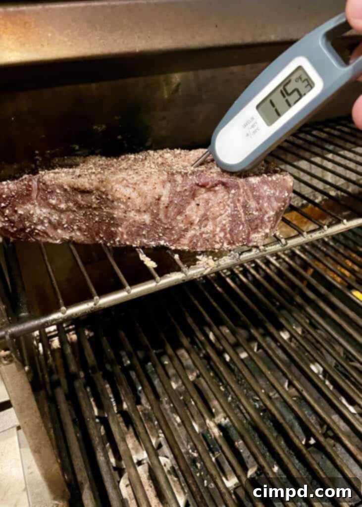 How to Reverse Sear a Steak: checking internal temperature with a thermometer