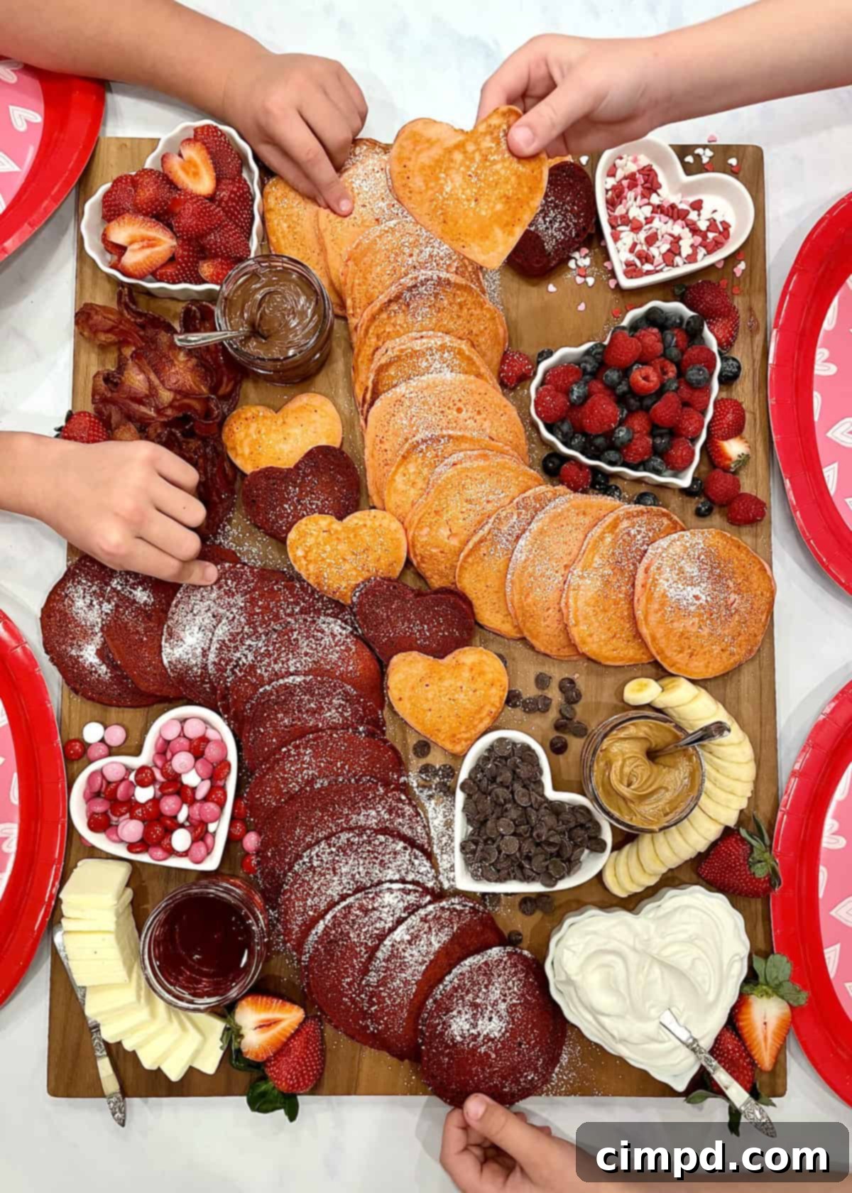 Love Day Pancake Brunch Board 8 A fully assembled Valentine's Day Pancake Board with various toppings and heart-shaped foods.