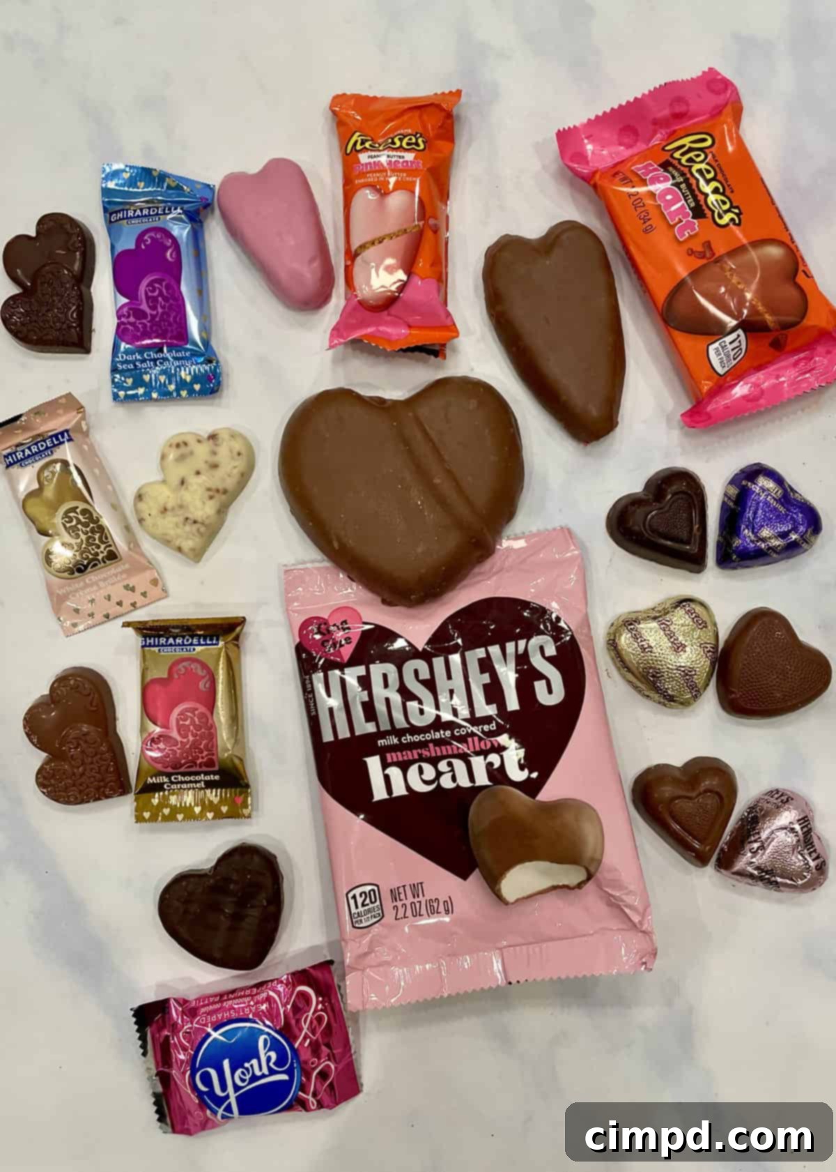 Various heart-shaped chocolates, cookies, and marshmallows on a Valentine's Day S'mores Tray.