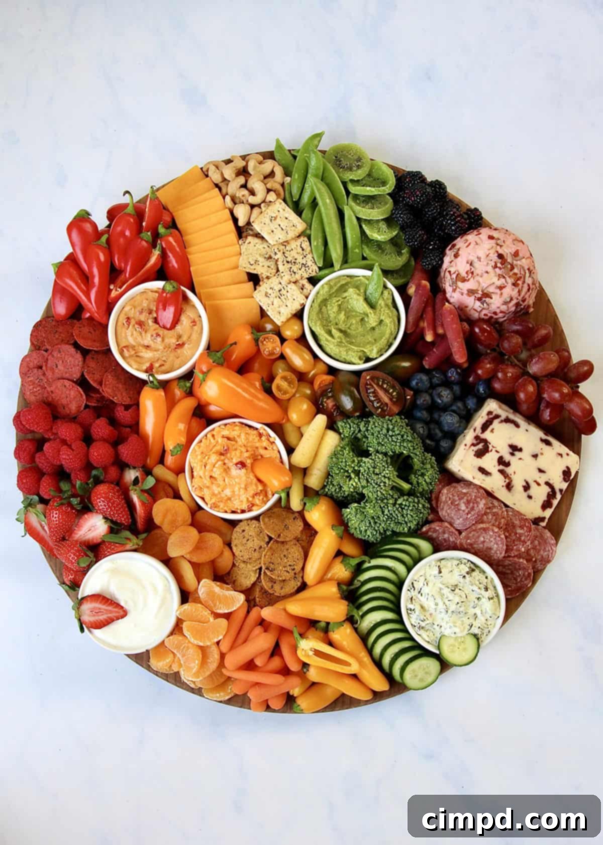 Close-up of a colorful array of fruits, vegetables, and cheeses on an Eat the Rainbow Snack Board by The BakerMama