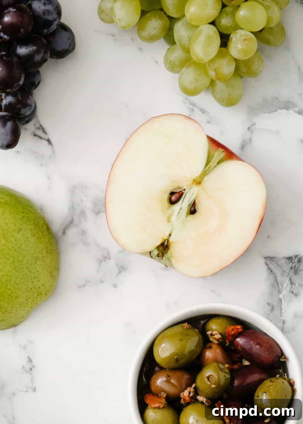 Freshly sliced apples arranged on a beautiful snack board, vibrant and unbrowned.