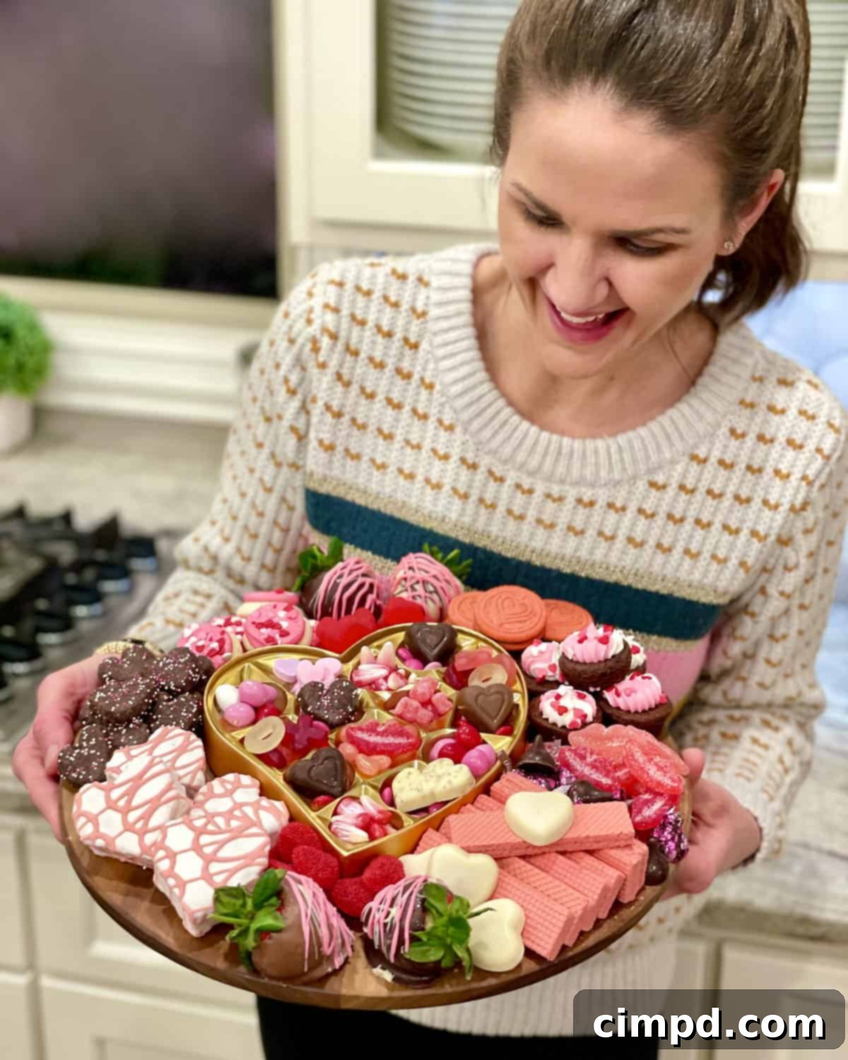 Close-up of a Galentine's Day Dessert Board featuring chocolate-dipped strawberries, cookies, and other pink and red treats.