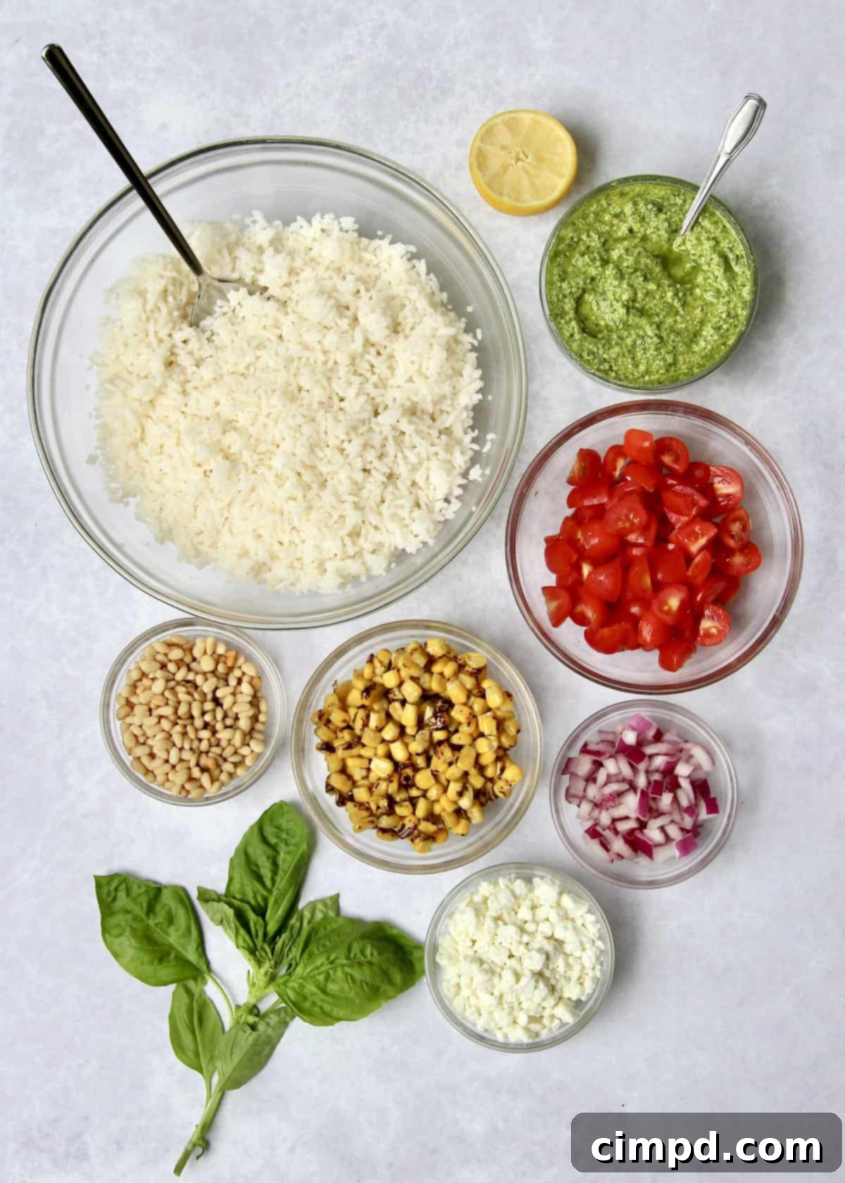 A close-up of vibrant green basil pesto in a food processor, ready to be blended into a smooth sauce.