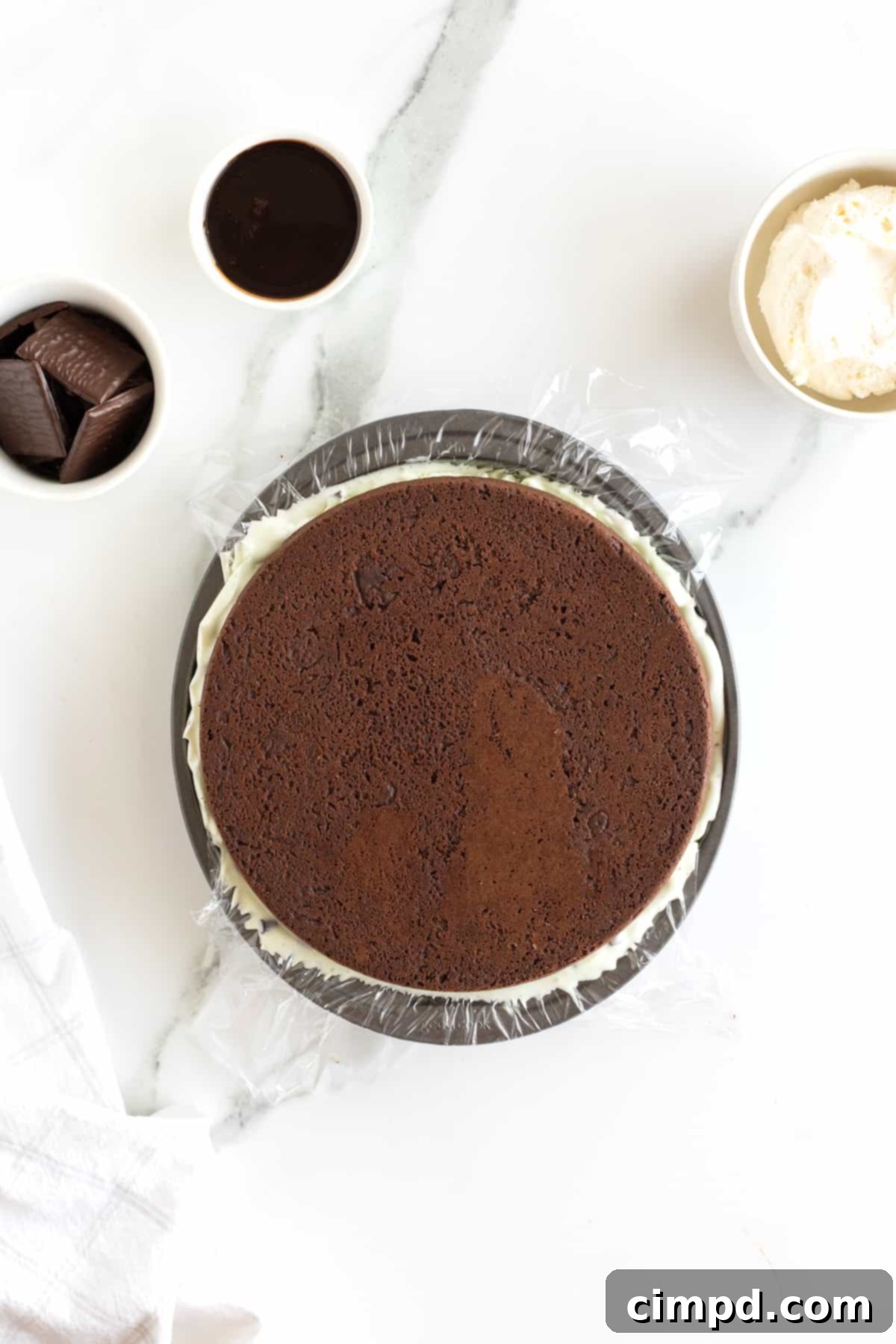 The top of an assembled chocolate chip ice cream sandwich cake, before topping.