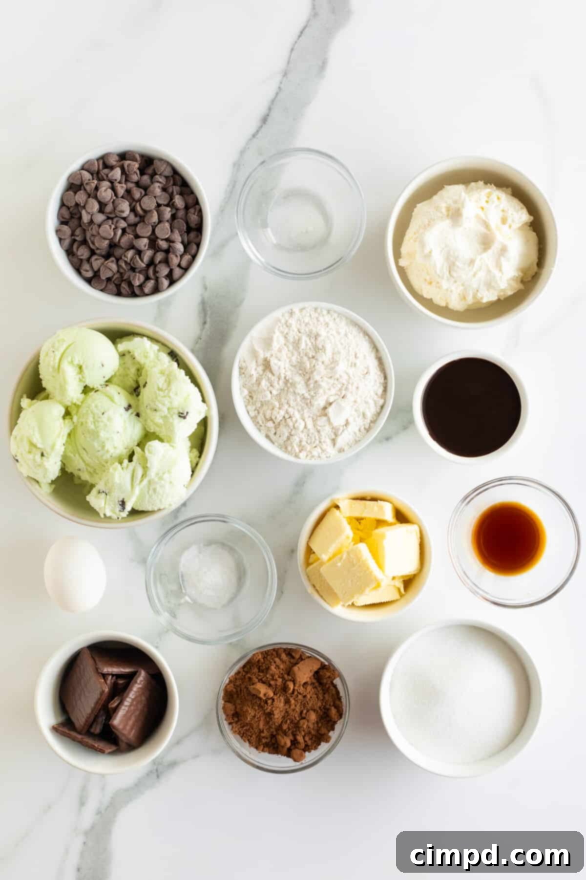 An array of ingredients for Mint Chocolate Chip Ice Cream Cake, neatly arranged in small bowls.