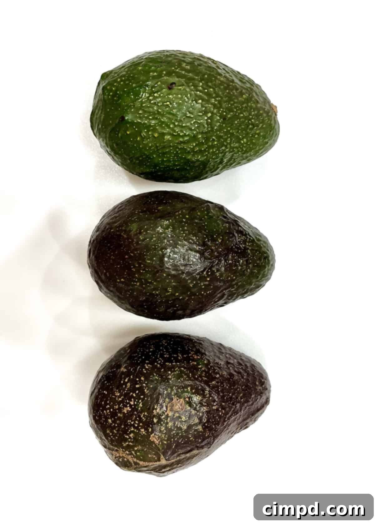 Visual guide demonstrating how to check an avocado's ripeness by pressing and examining the stem