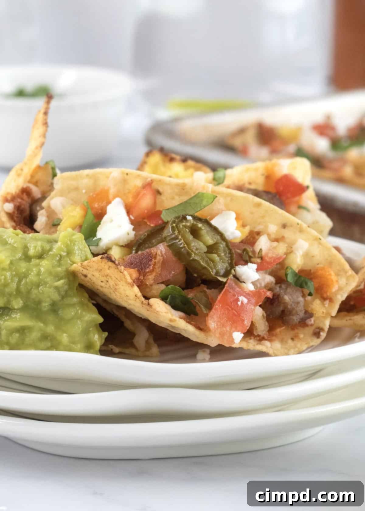 Rise and Shine Nachos 3 Close-up of a tray of freshly baked breakfast nachos with melted cheese and vibrant toppings.