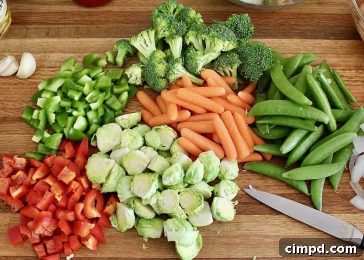 Unlock the Flavor of Roasted Vegetables 3 Freshly cut vegetables ready for roasting on a baking sheet