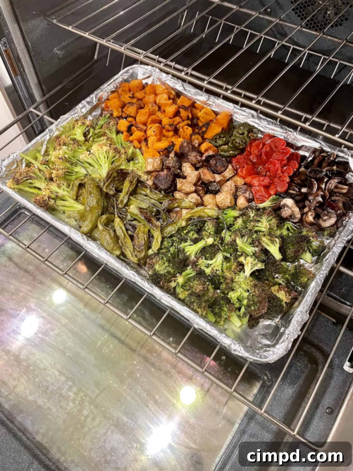 Unlock the Flavor of Roasted Vegetables 5 Assortment of roasted vegetables on a baking sheet by The BakerMama