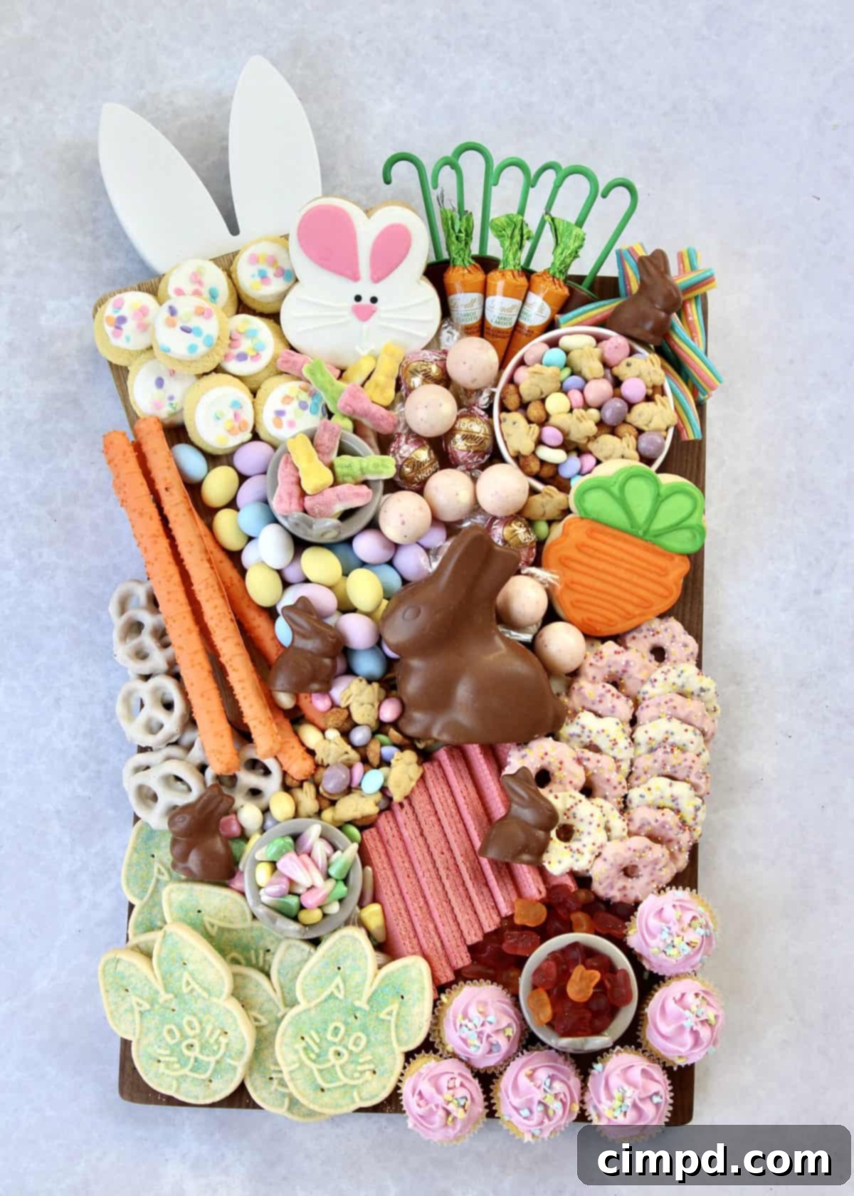 A beautifully arranged Bunny Treats Board, perfect for Easter celebrations, featuring a variety of sweet and savory treats, vibrant candies, and chocolate bunnies.