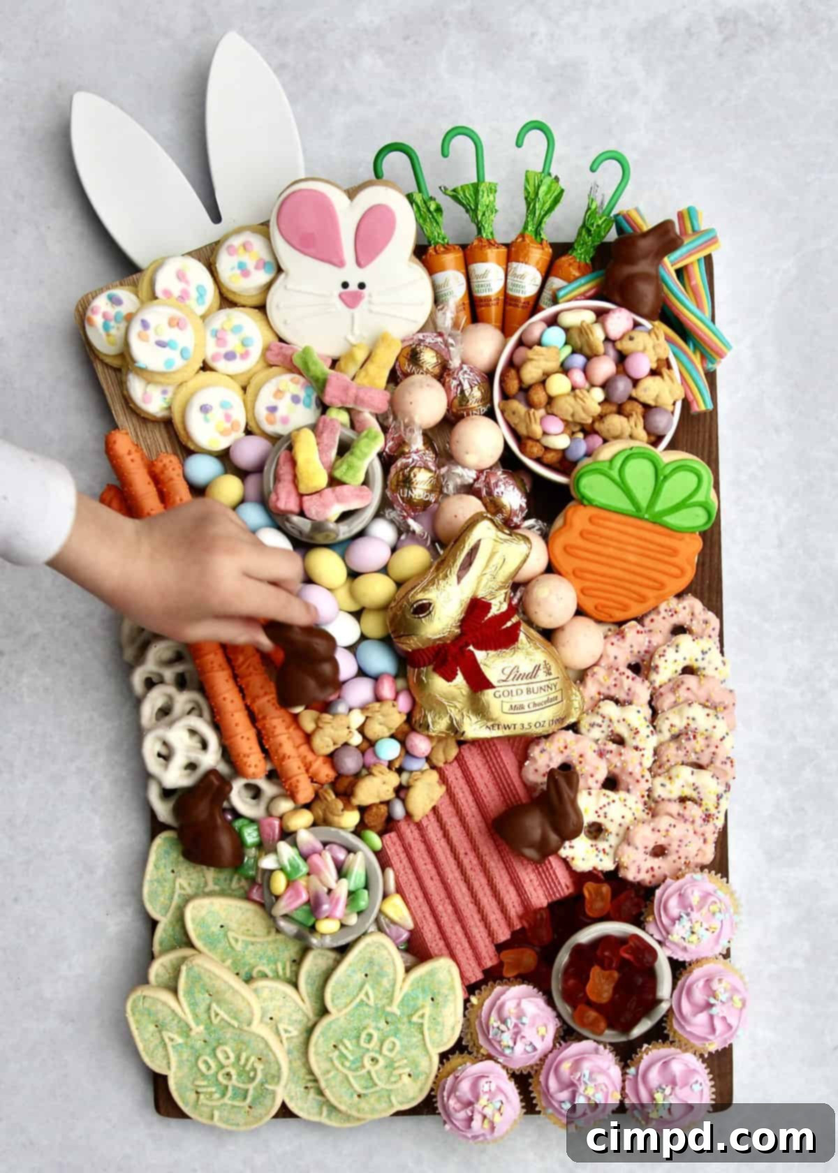 An overhead view of the Bunny Treats Board featuring various candies, cookies, and chocolates, ready for an Easter celebration.