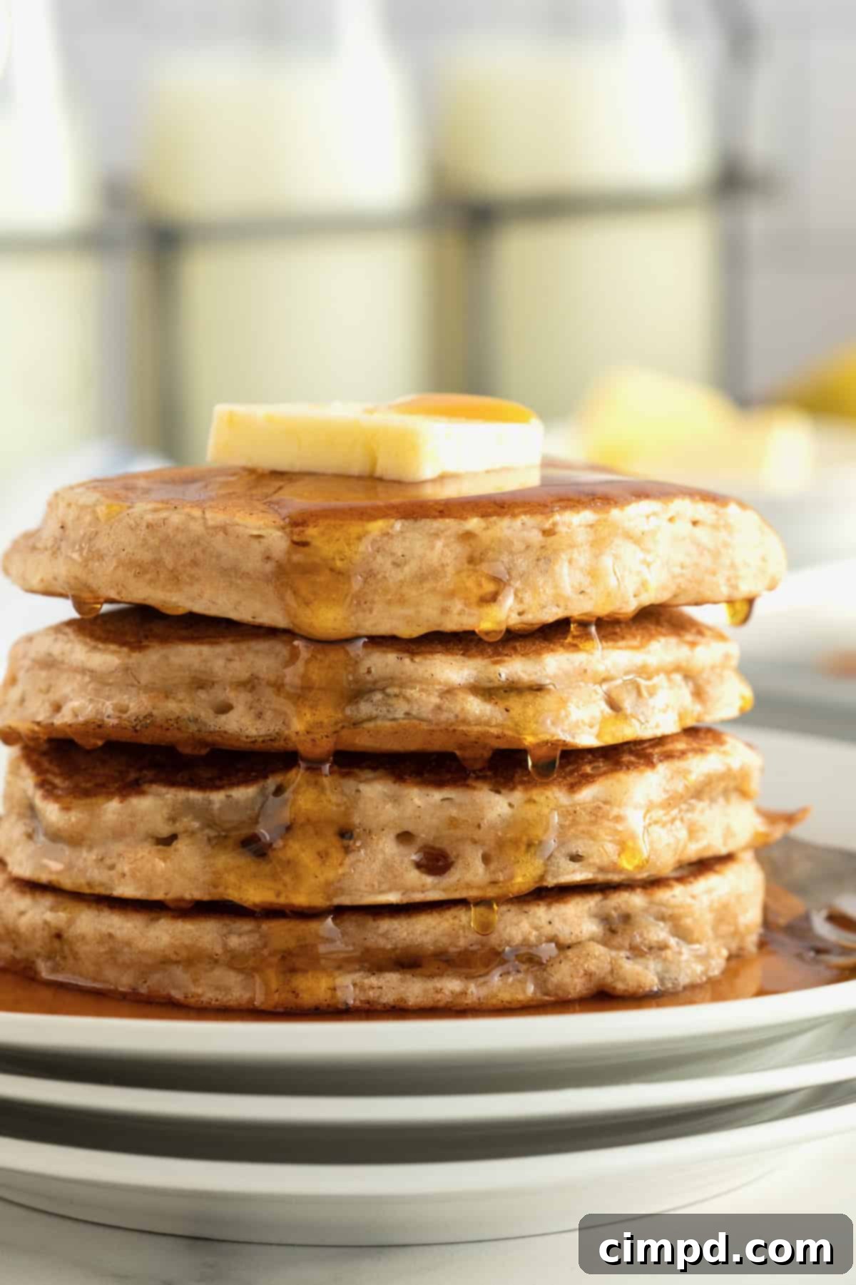 A beautifully plated stack of Whole Wheat Banana Pancakes.