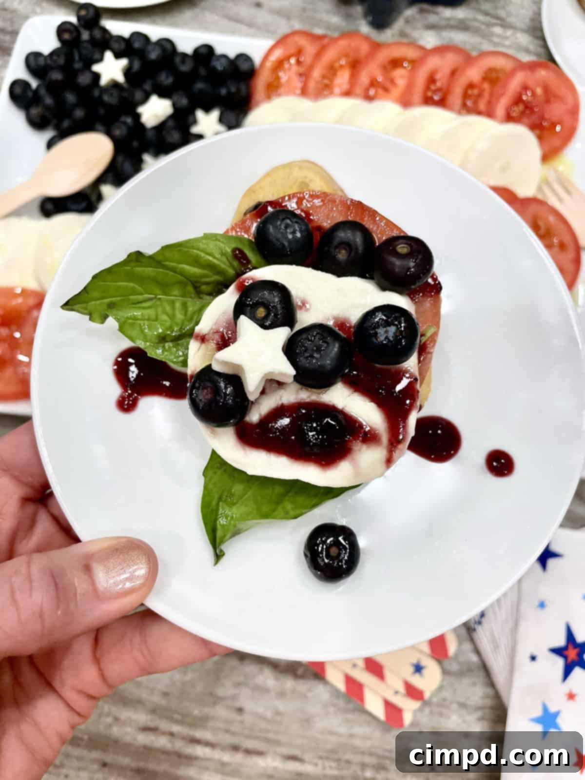Close-up of the American Flag Caprese Salad, highlighting the fresh blueberries and mozzarella stars.