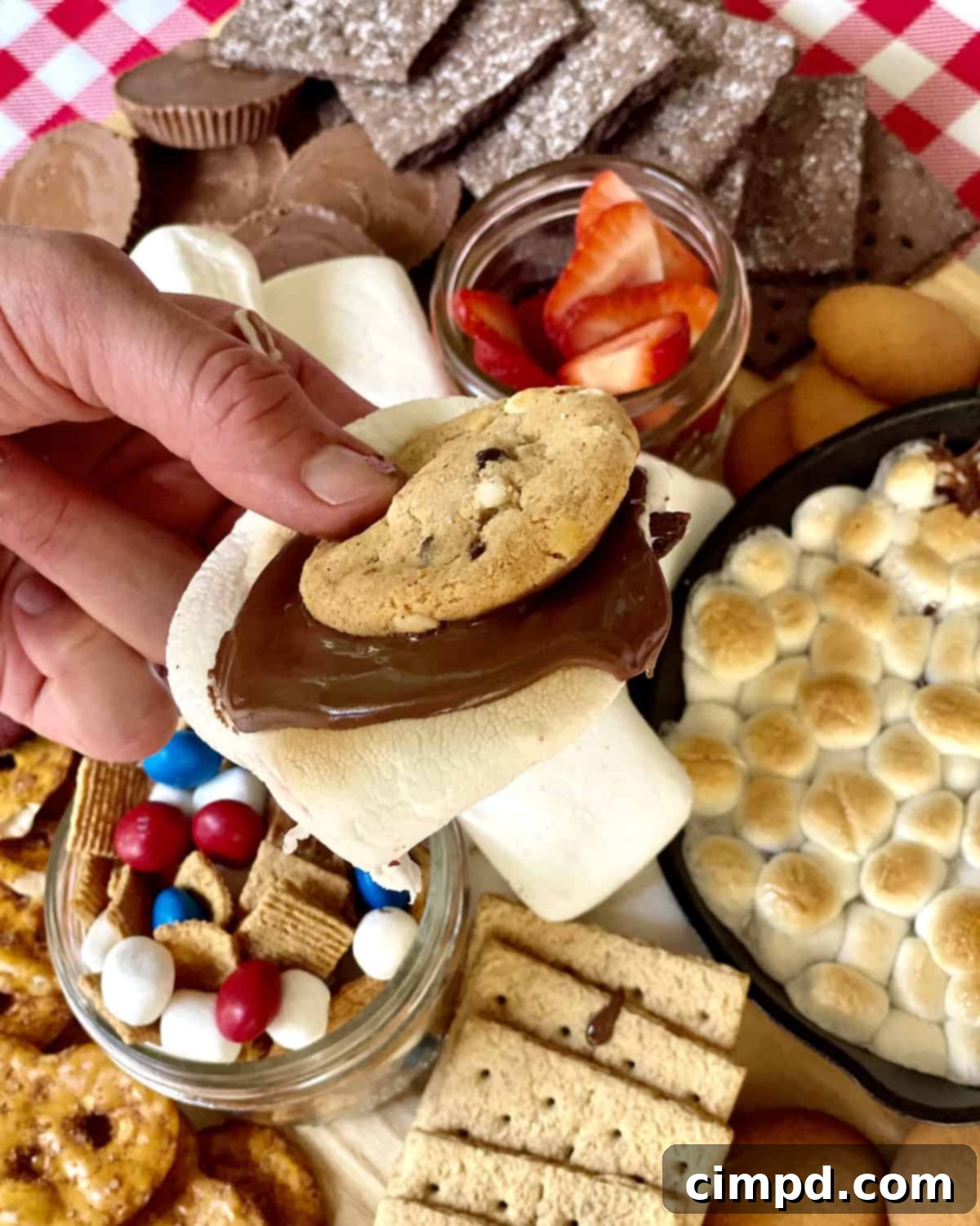 A comprehensive view of The Ultimate Summer Cookout Spread, showcasing the hot dog and burger bar, fresh fruits, and the s'mores dessert board.