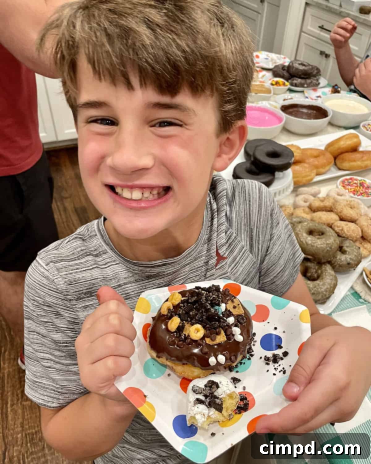 DIY Donut Decorating Bar 3 Decorate Your Own Donut Spread with a child enjoying their creation