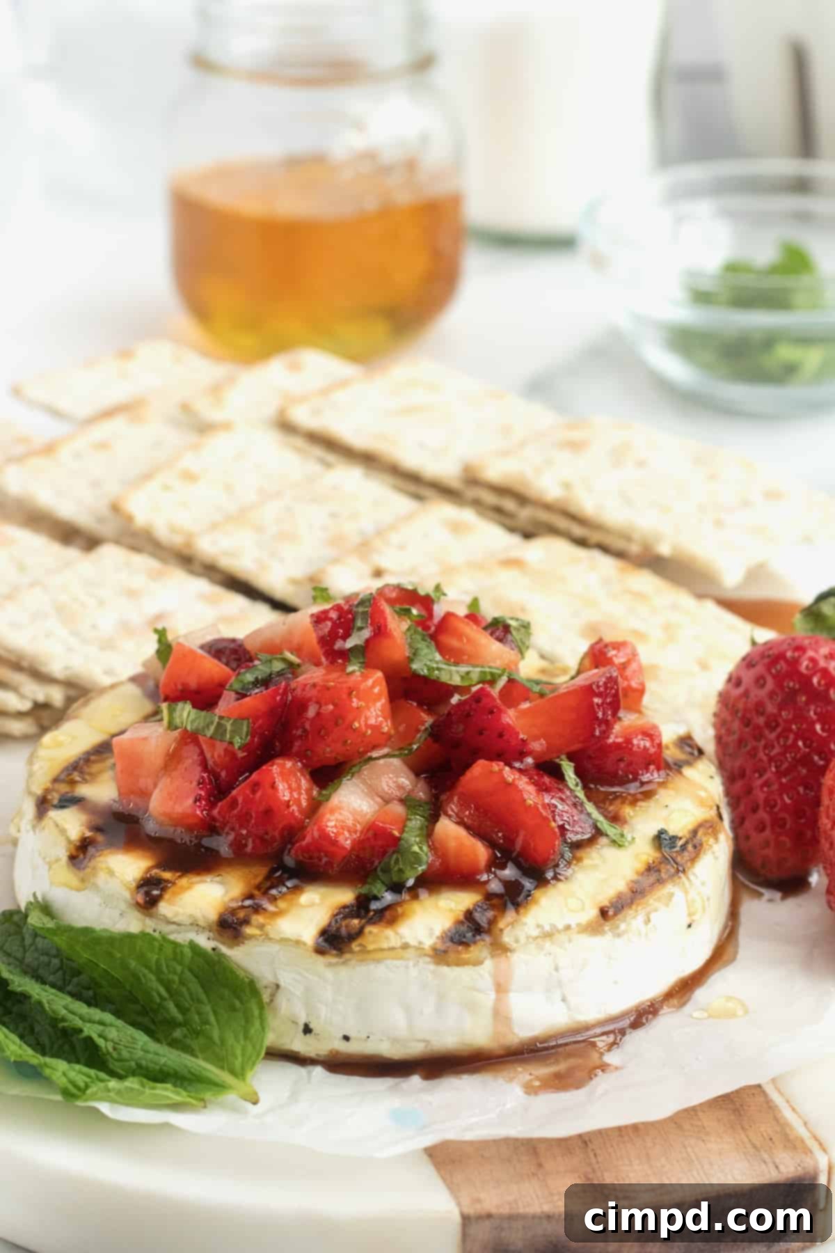 A beautifully presented summer spread featuring Grilled Brie with Strawberries