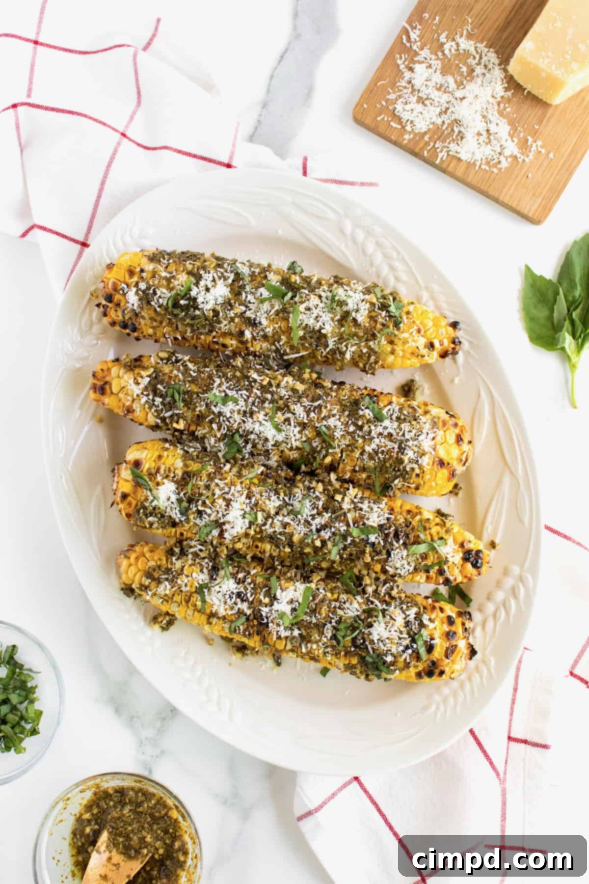Grilled Corn with Pesto and Parmesan 2 Pesto Parmesan Grilled Corn, a flavorful summer side dish by The BakerMama