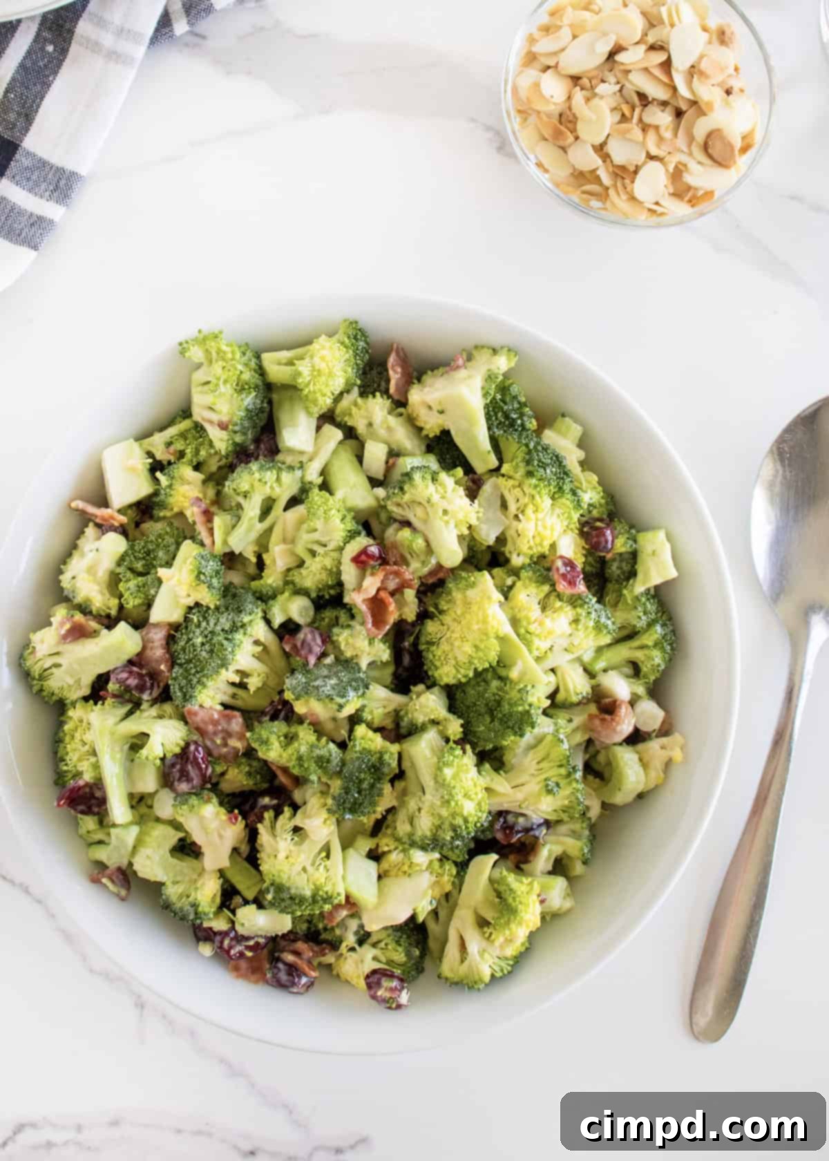 A finished bowl of Creamy Broccoli Salad, garnished and ready to be served.