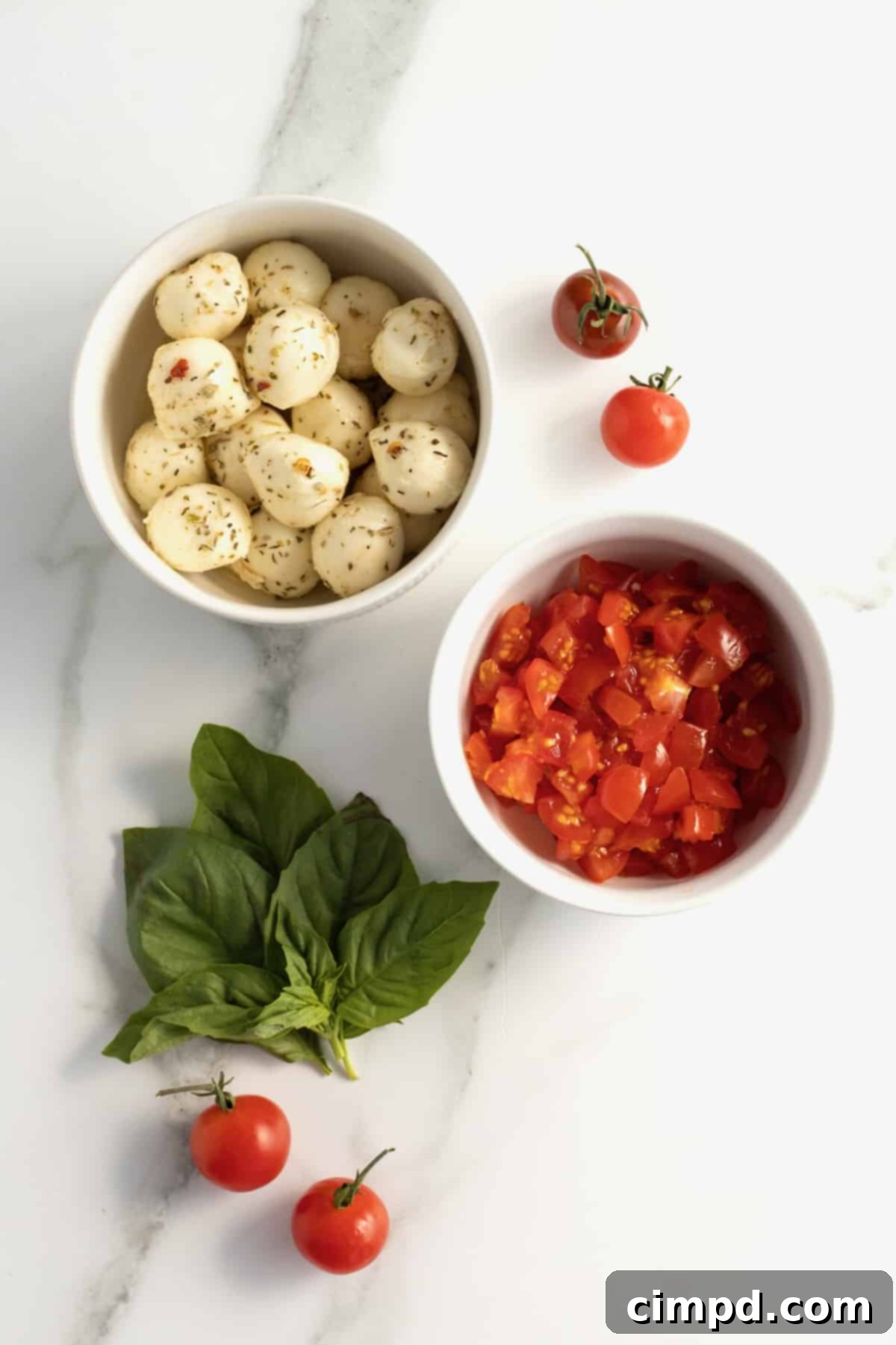 Bubbly Baked Caprese Dip 5 Ingredients laid out for Skillet Caprese Dip: mozzarella, tomatoes, basil