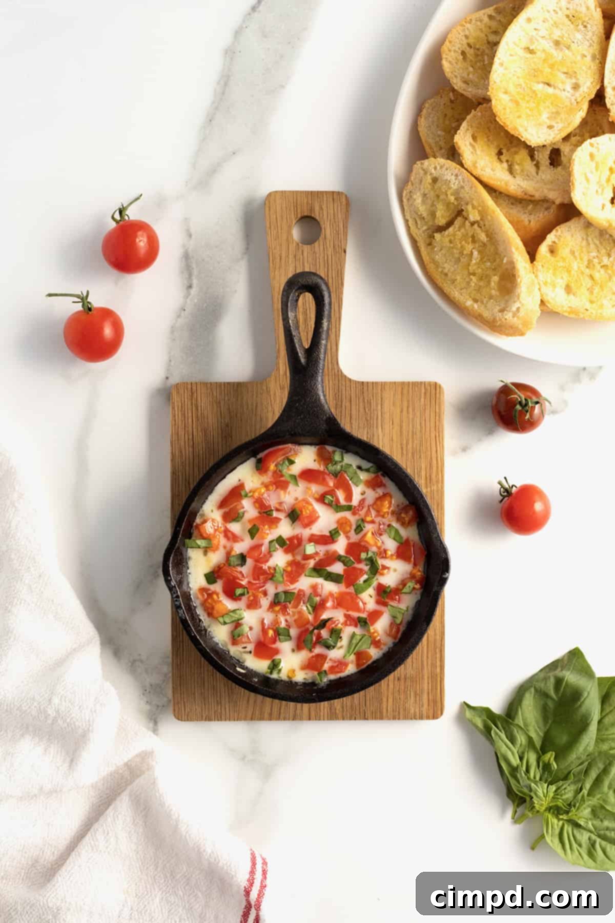 Bubbly Baked Caprese Dip 7 Finished Skillet Caprese Dip, garnished with fresh basil and diced tomatoes