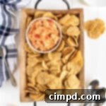 Pimento Cheese Dip on a tray with chips by The BakerMama