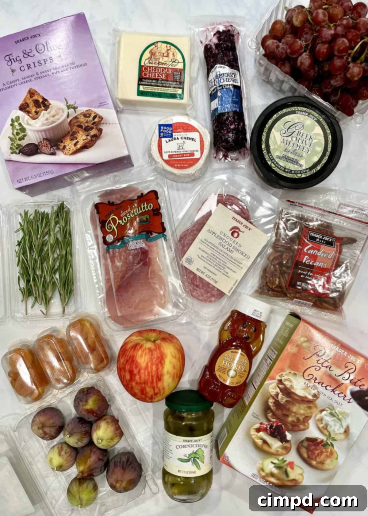 A close-up view of the fresh and carefully selected ingredients from Trader Joe's, including various cheeses, cured meats, olives, honey, and fruits, ready to be assembled into a delectable mini charcuterie board.