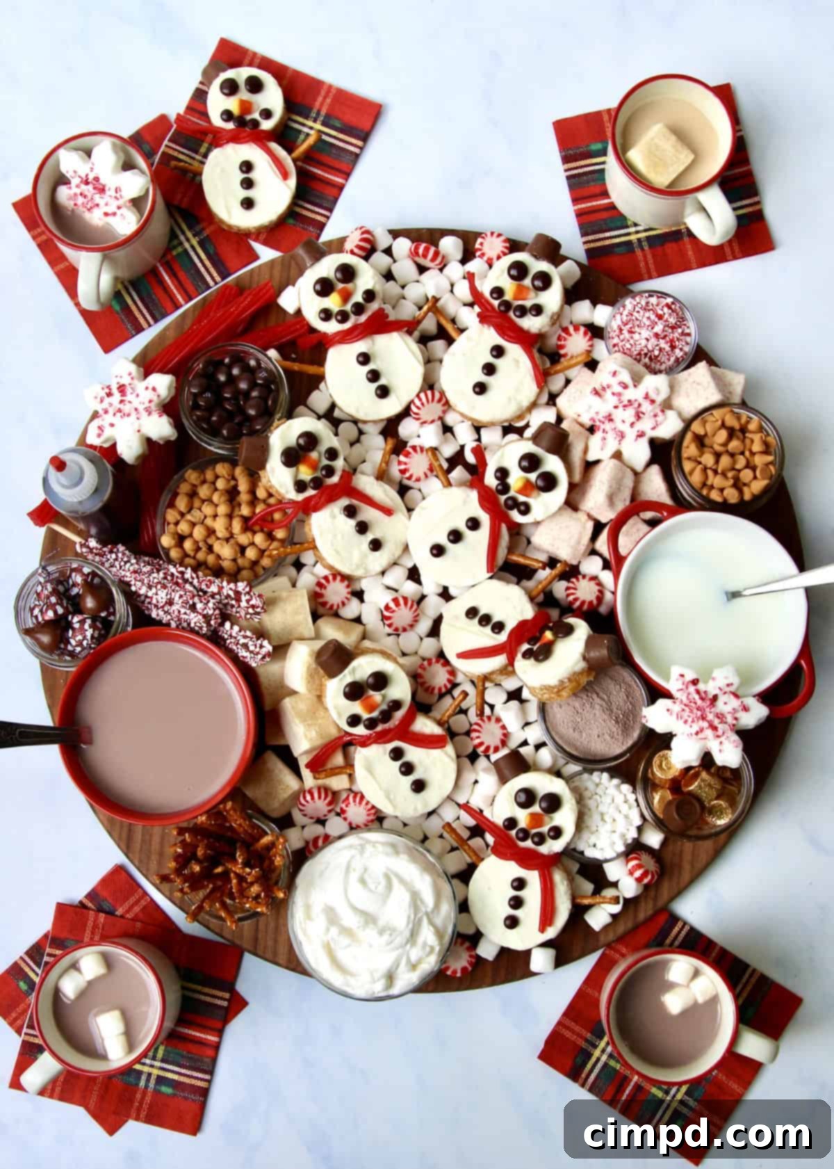 Festive Hot Chocolate Board and Snowman Scotcheroos 2 A beautifully arranged Hot Chocolate Board featuring Snowman Scotcheroos, surrounded by an array of toppings like marshmallows, pretzels, and candies, set for a festive holiday gathering.
