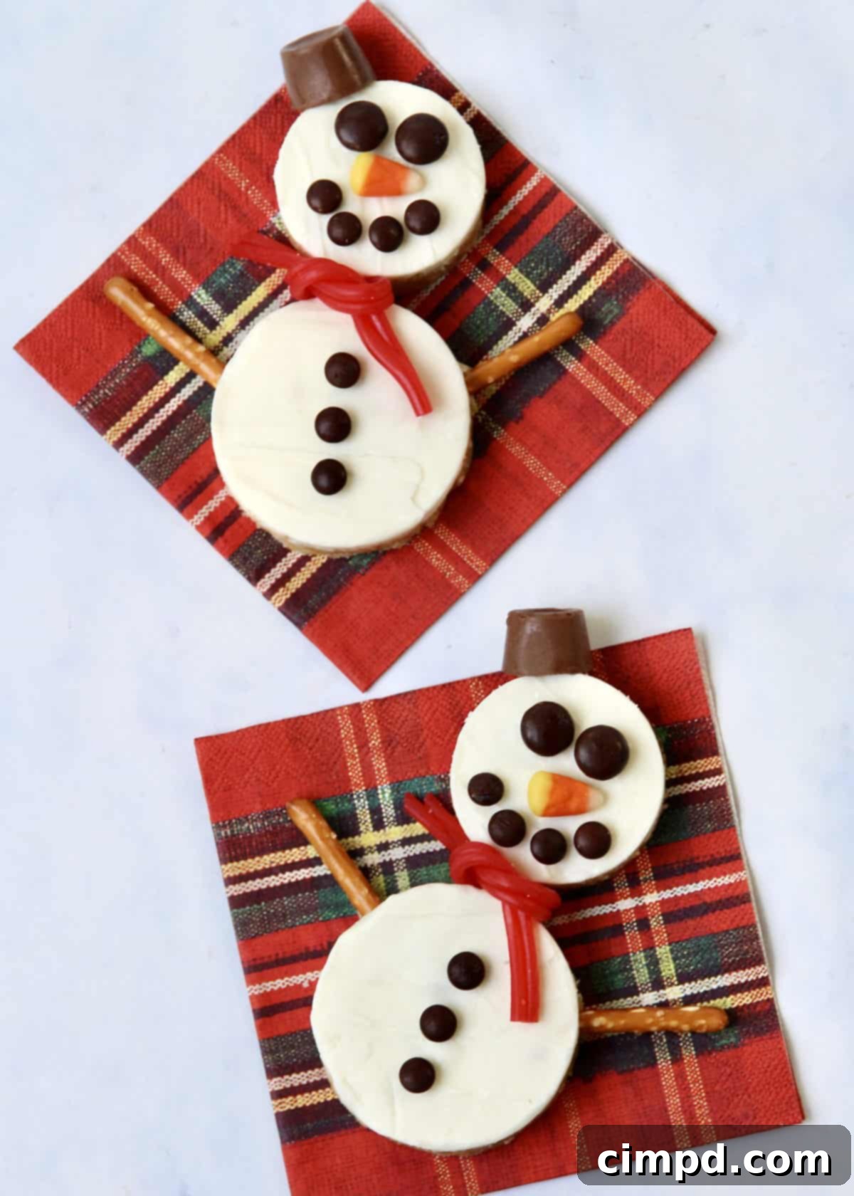 Festive Hot Chocolate Board and Snowman Scotcheroos 4 A close-up view of the smooth, melted white chocolate topping being spread evenly over the scotcheroo mixture in a baking pan.