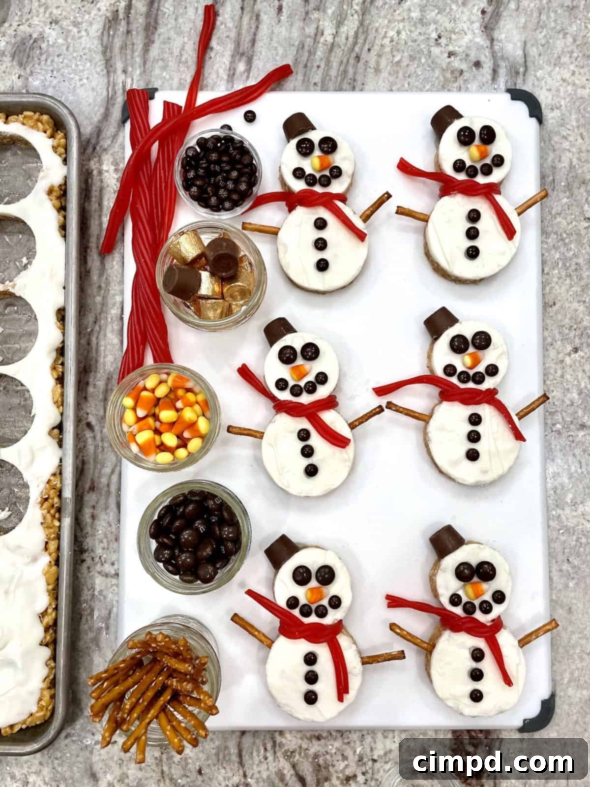Festive Hot Chocolate Board and Snowman Scotcheroos 7 A complete Hot Chocolate Board featuring an abundance of toppings and the charming Snowman Scotcheroos, artfully arranged and ready for guests to enjoy.