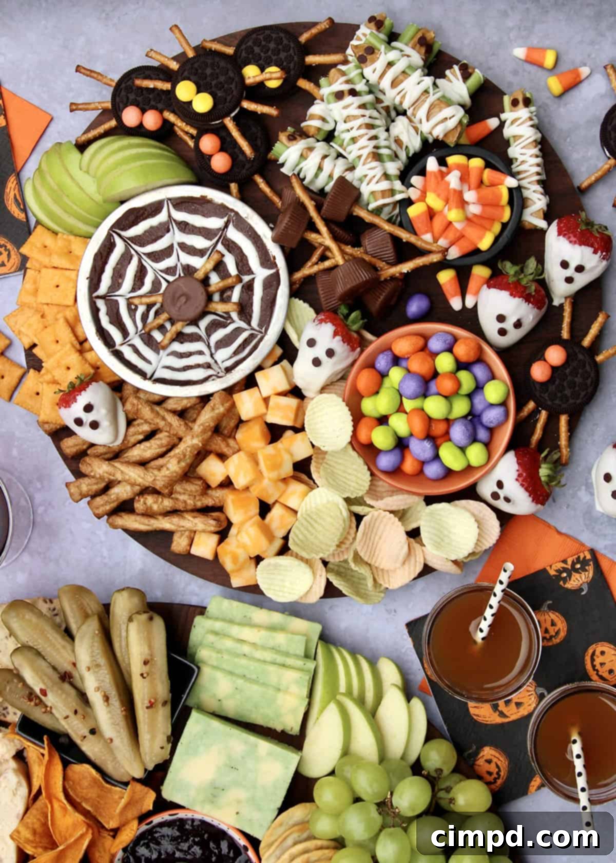 Close-up of Spider Web Brownie Batter Hummus Dip and Cookie Spiders on a Halloween snack board