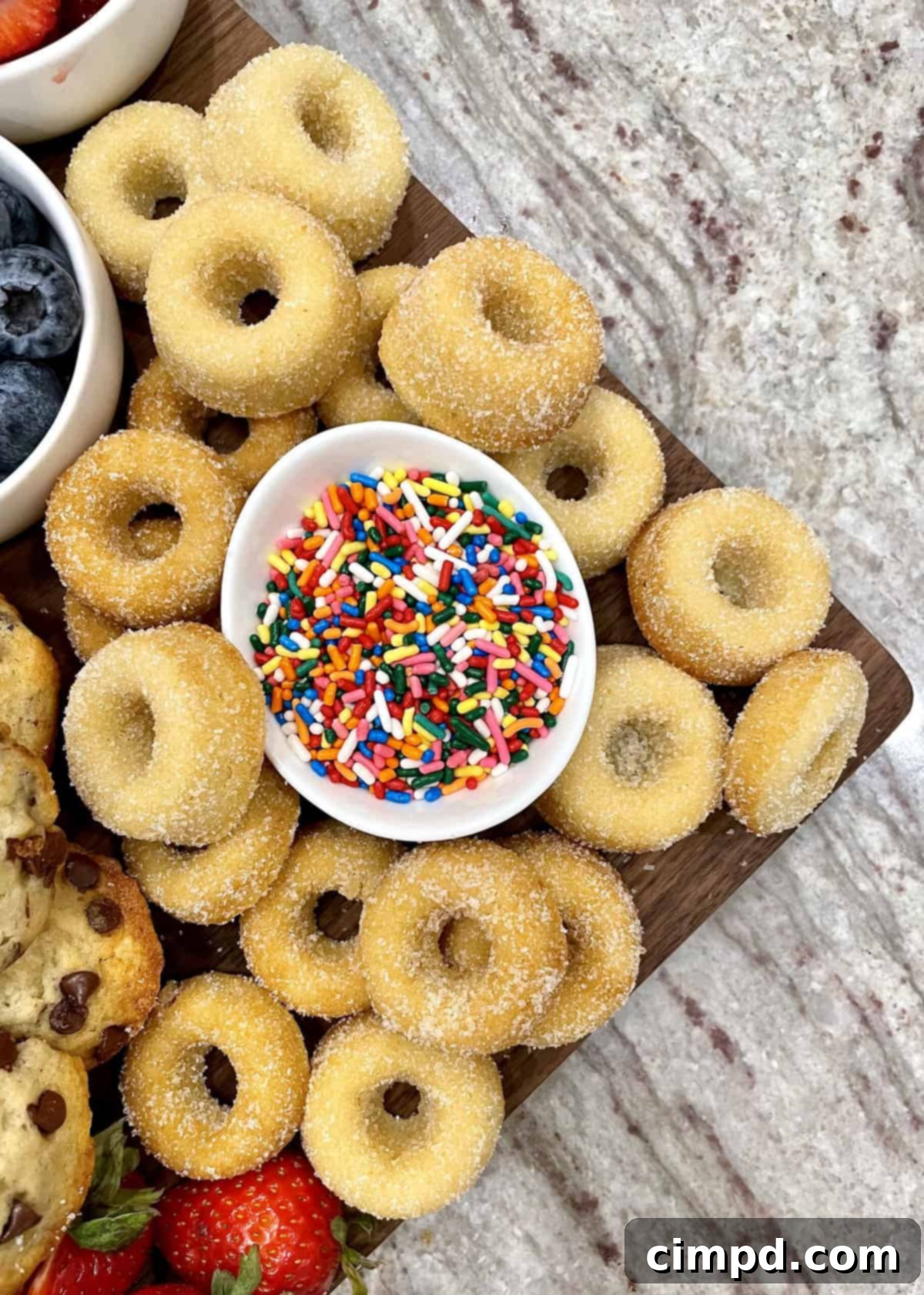 Close-up on the Mini Sugar-Coated Baked Donuts section of the breakfast board.