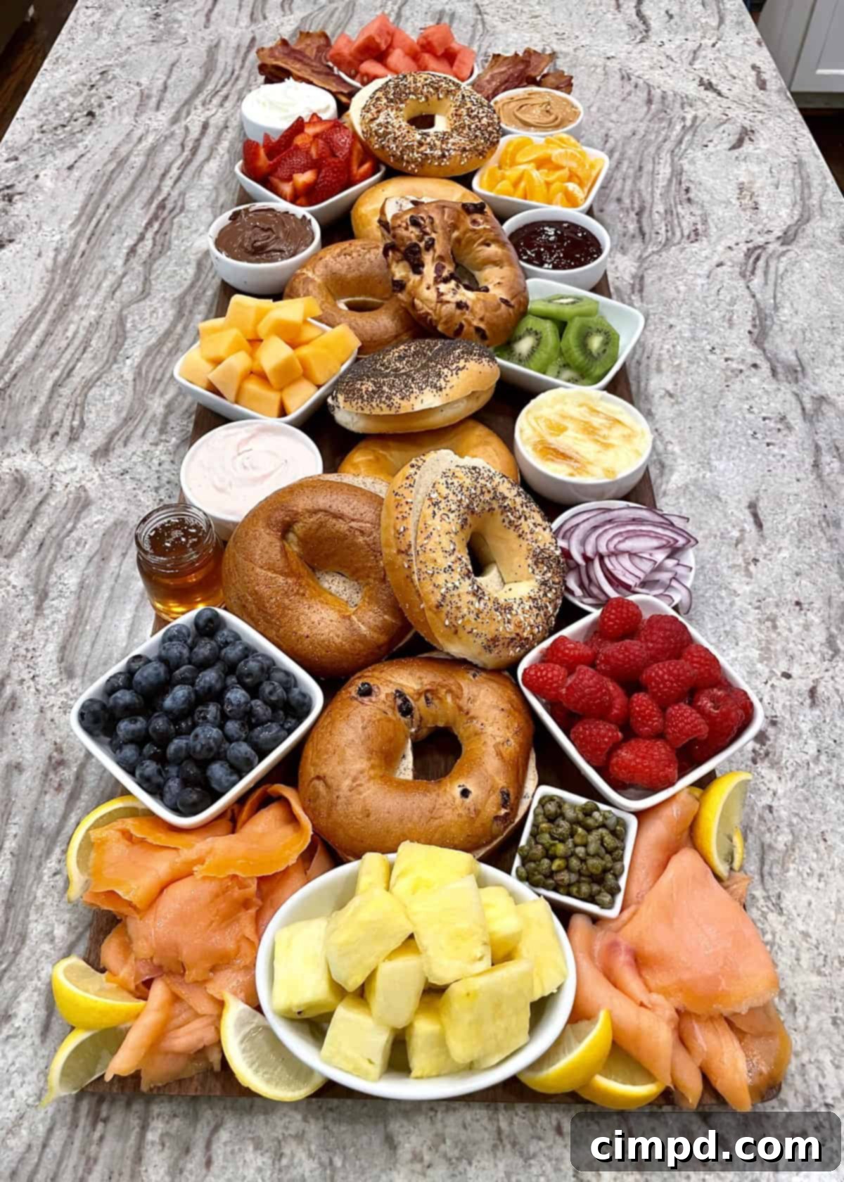 The Ultimate Bagel Board by The BakerMama - A customizable brunch spread with fresh bagels, cream cheeses, fruits, and savory toppings