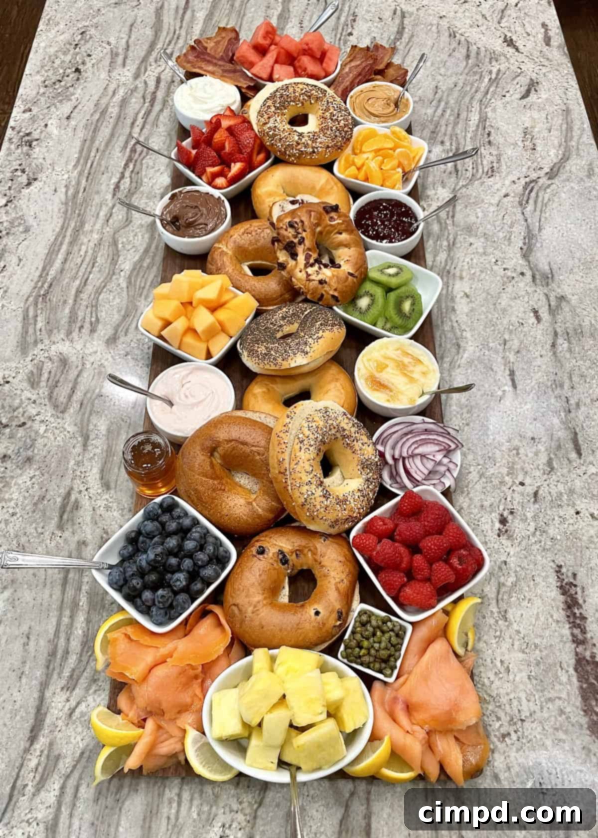 A beautifully arranged Bagel Board, showcasing various toppings like fruit, cream cheese, and salmon, perfect for a gourmet breakfast or brunch.