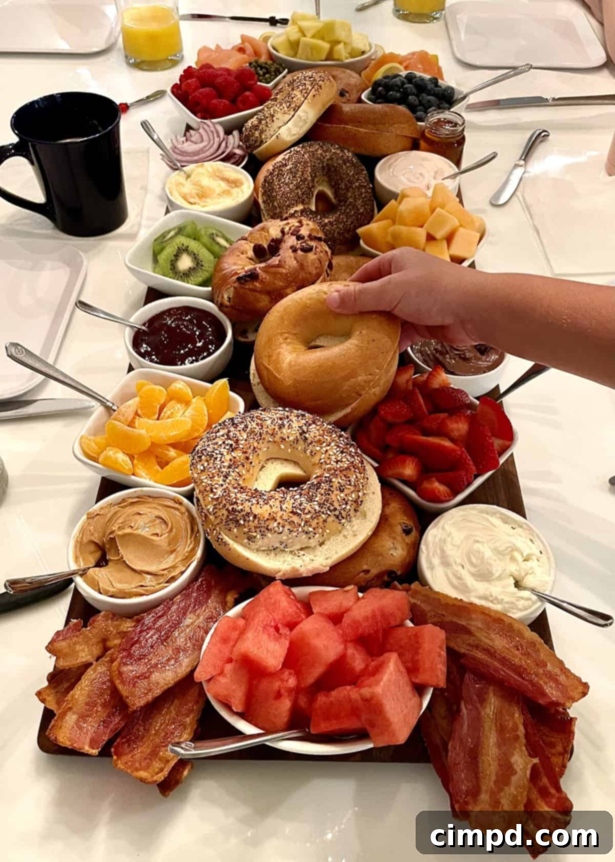 Close-up of a beautifully arranged Bagel Board with an array of colorful fruits, fresh bagels, and diverse spreads