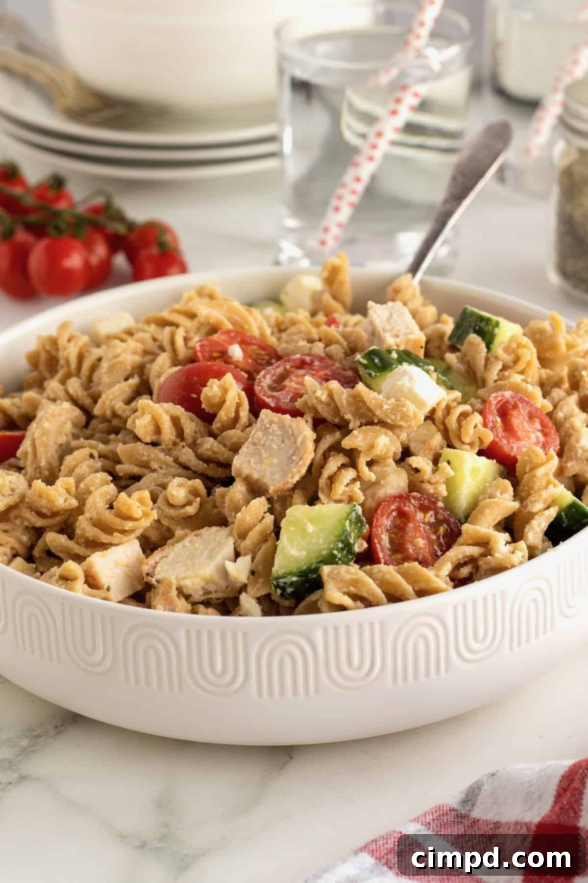 The process of mixing hummus into warm pasta