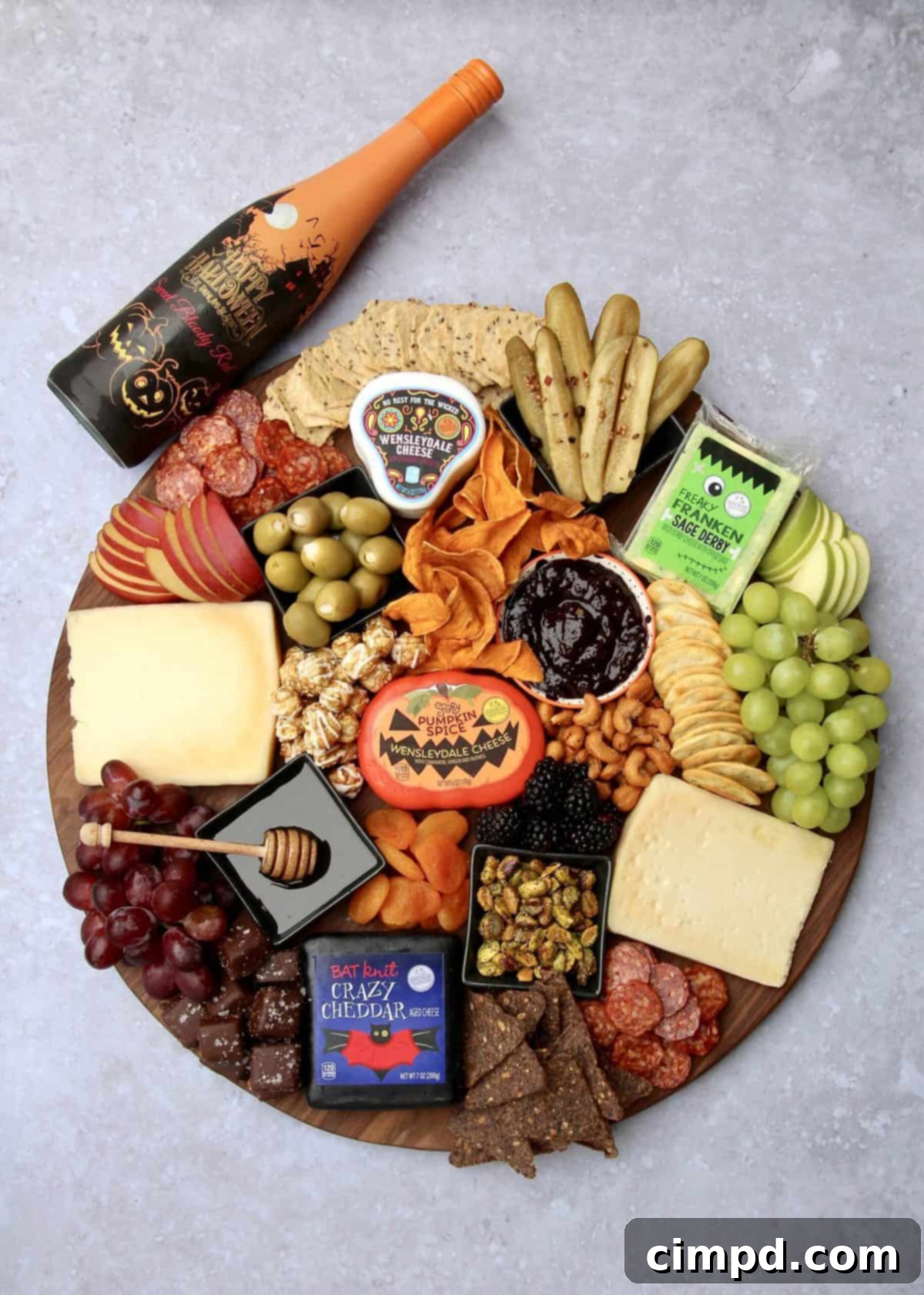 The Halloween Cheese Board, ready to be served, with an inviting array of treats and decorative elements, by The BakerMama.