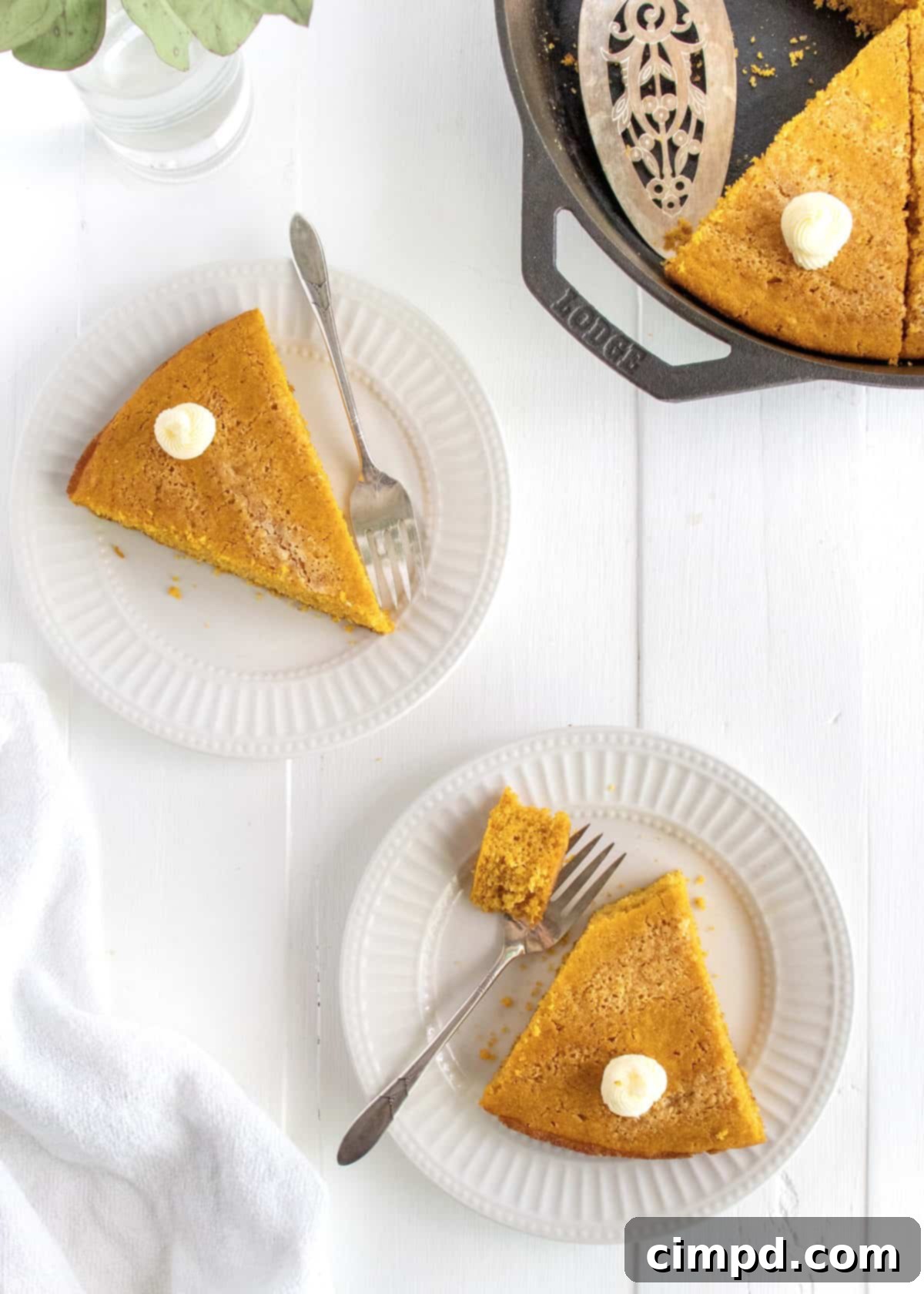 Spiced Pumpkin Cornbread 3 Close-up of Pumpkin Cornbread with dollops of butter, resembling a pie.