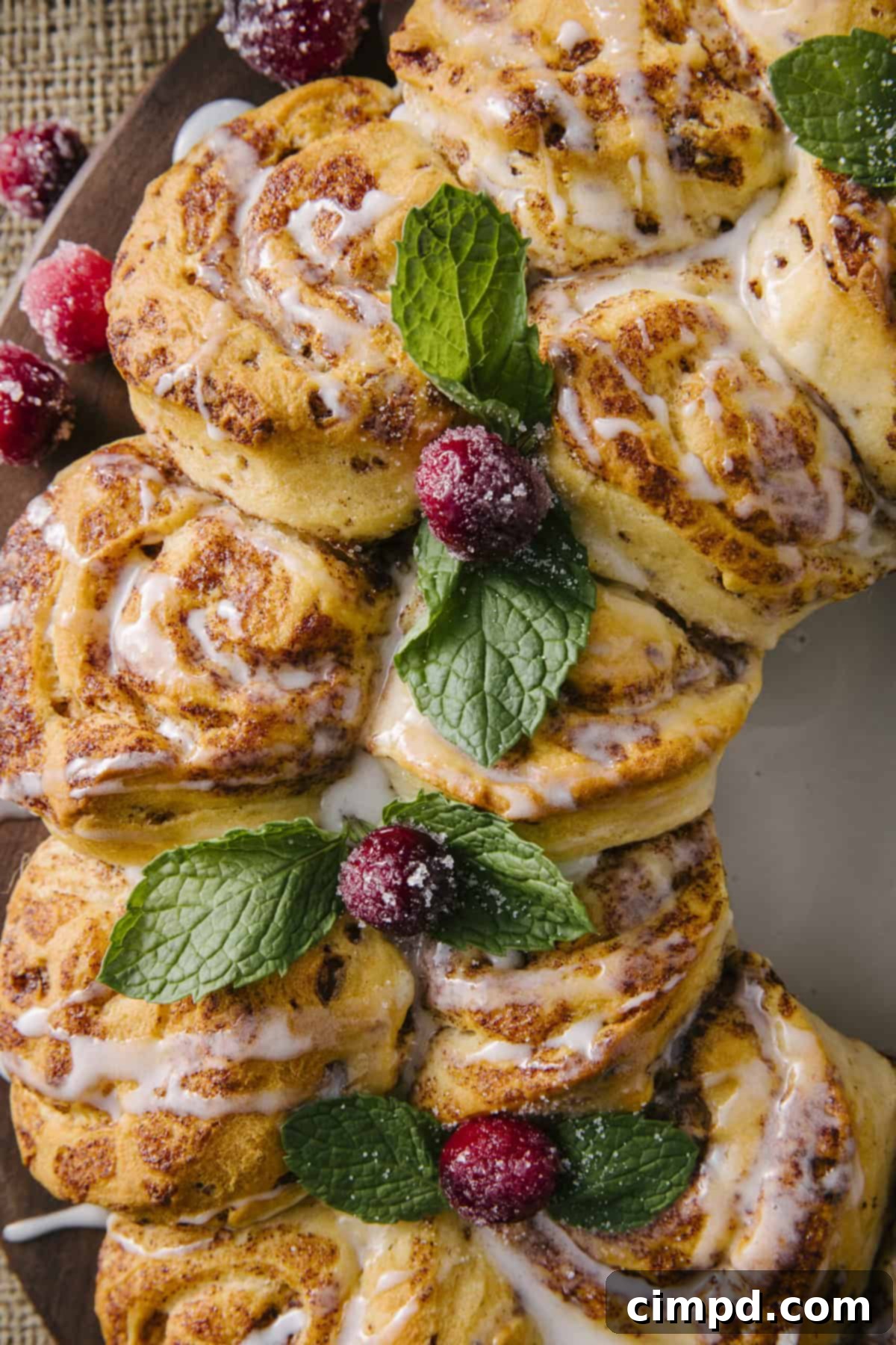 Close-up of a festive Cinnamon Roll Wreath, showcasing its perfect circular shape and golden-brown crust.