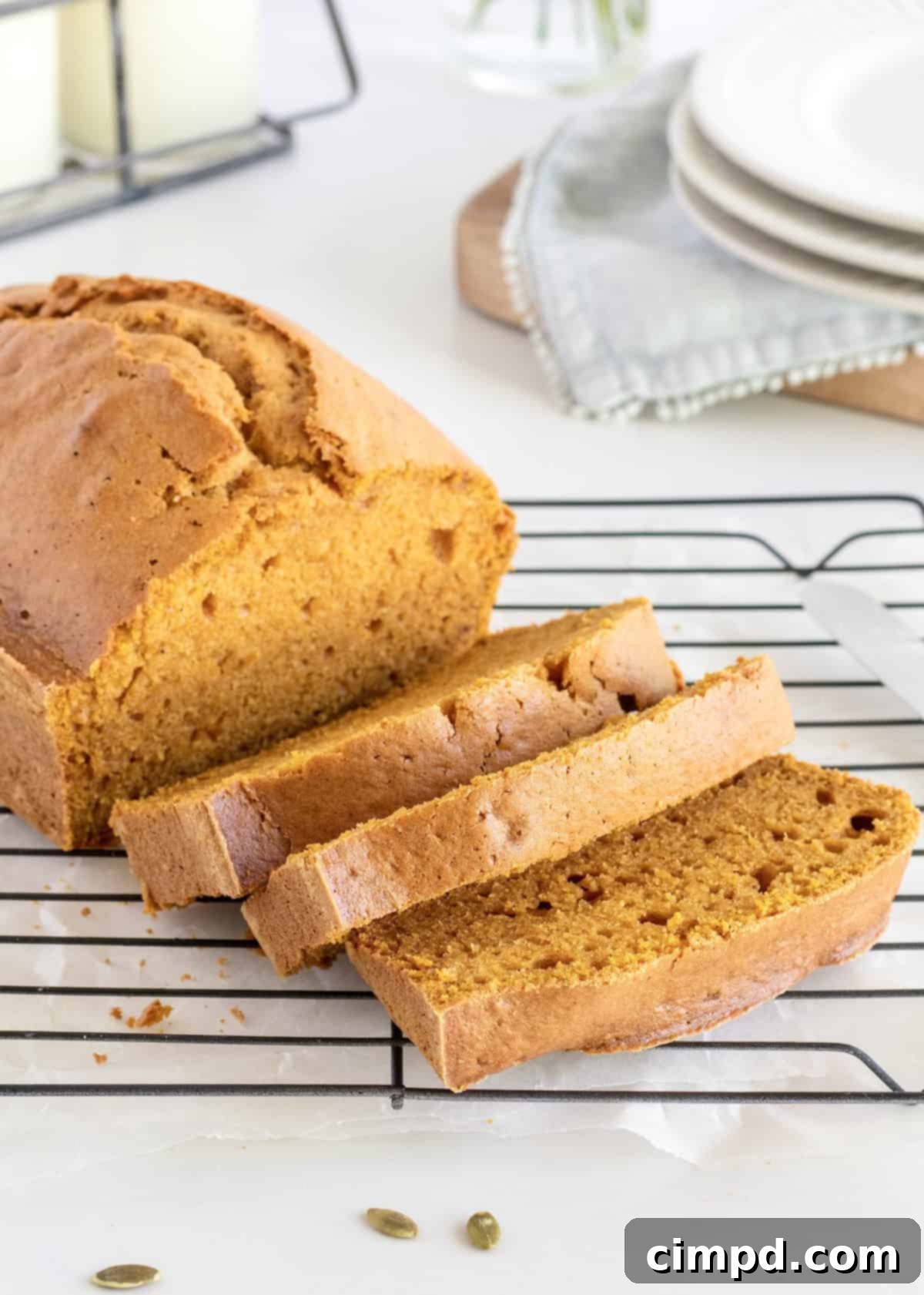 Warm slices of Perfect Pumpkin Bread with a pat of melting butter