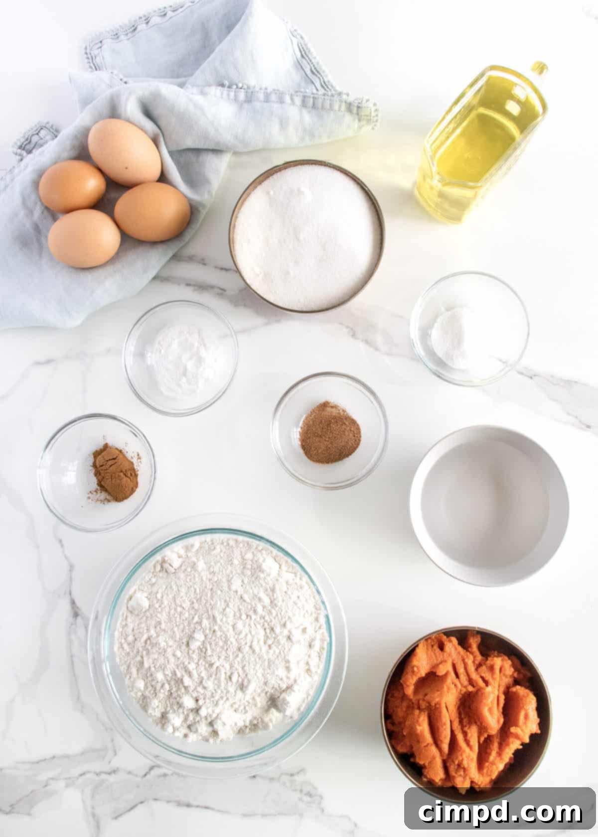 Ingredients for homemade pumpkin bread displayed on a counter