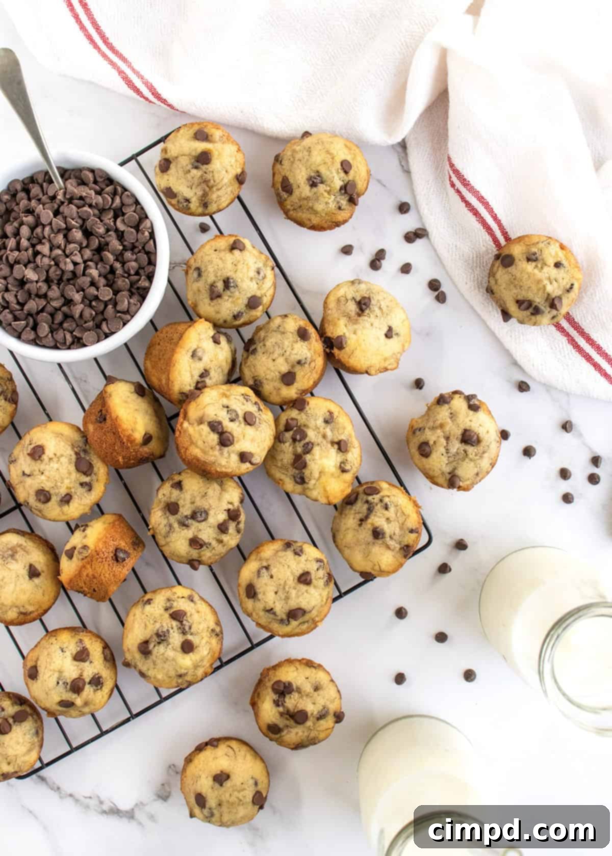Delicious Mini Banana Chocolate Chip Muffins by The BakerMama, perfectly baked and golden brown.