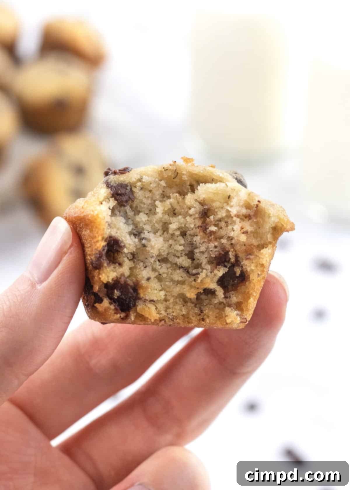 Close-up of Mini Banana Chocolate Chip Muffins stacked on a plate, showcasing their fluffy texture and chocolate chips.