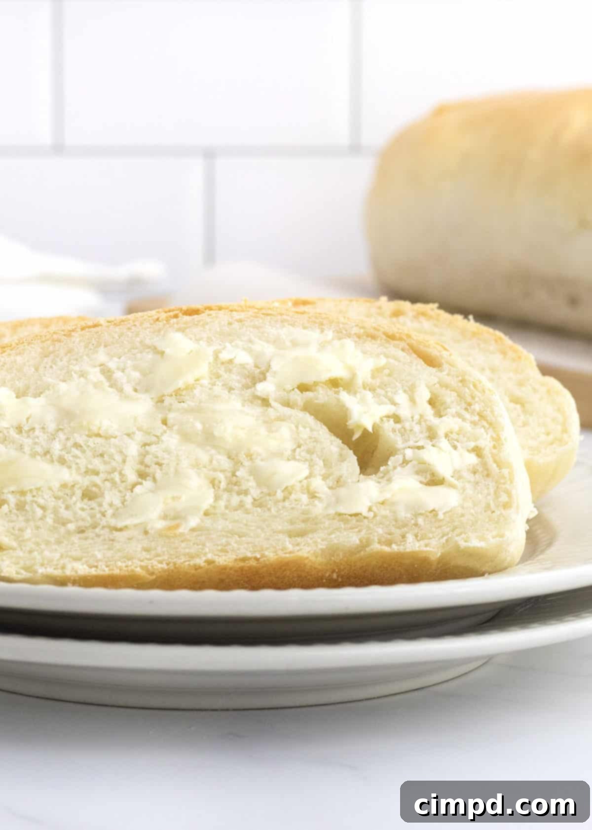 Two golden, perfectly baked loaves of 5-Ingredient Homemade French Bread cooling on a wire rack, indicating a successful bake.