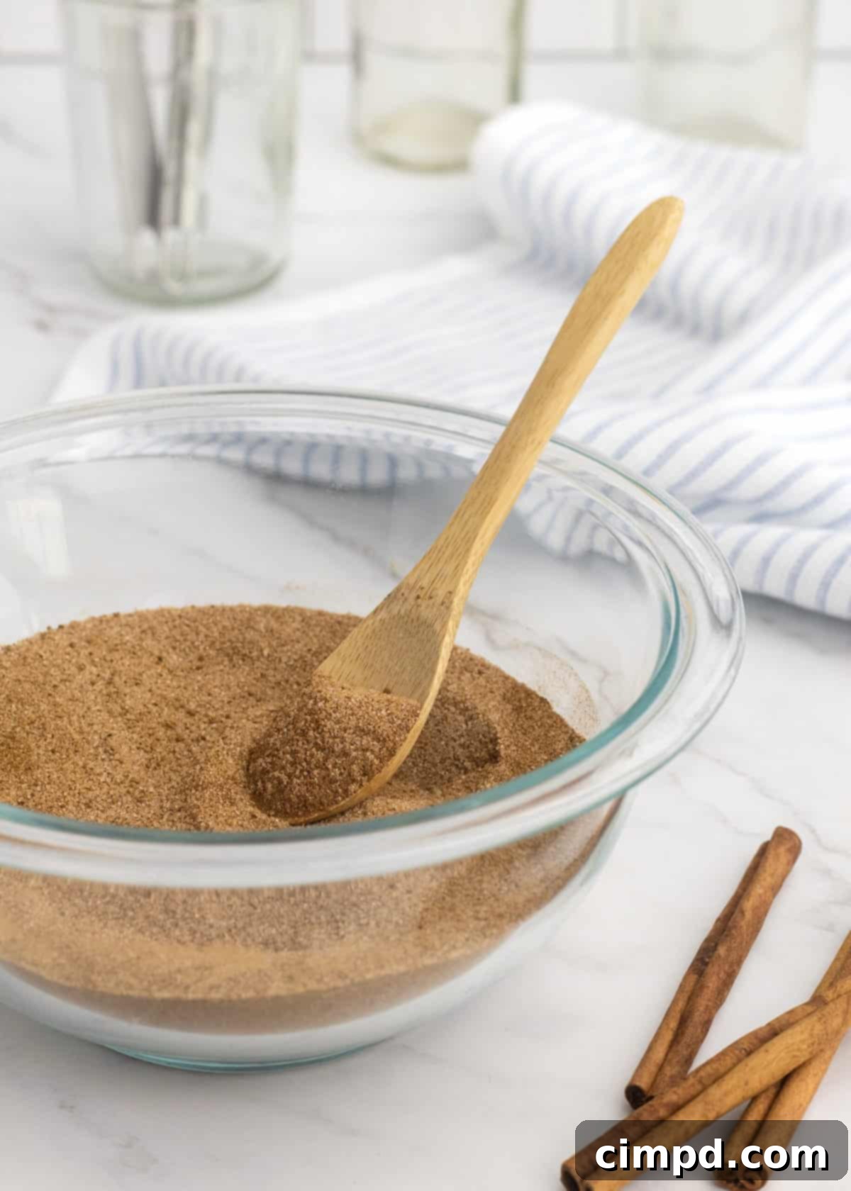 Freshly mixed cinnamon sugar in a small bowl with a whisk, ready for use, by The BakerMama