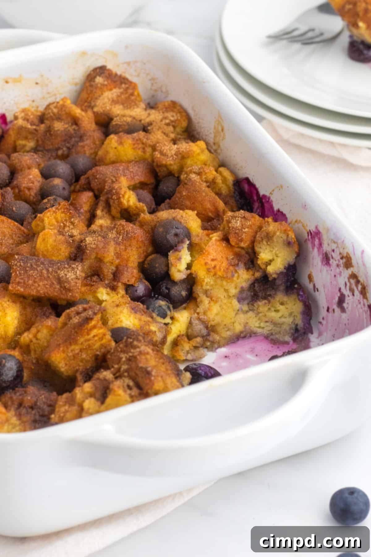 Delicious Blueberry French Toast Casserole, golden brown and topped with fresh blueberries.