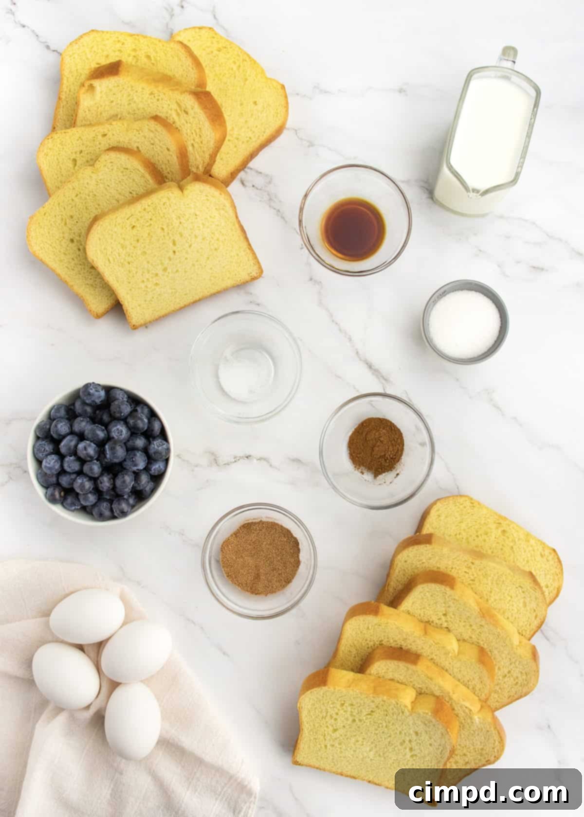 Ingredients for Blueberry French Toast Casserole laid out on a table.
