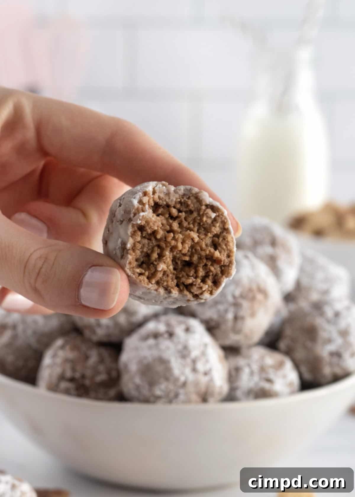 Sweet Dust Squares 3 Close-up of freshly made Muddy Buddy Bites, showing their perfect spherical shape and powdered sugar coating