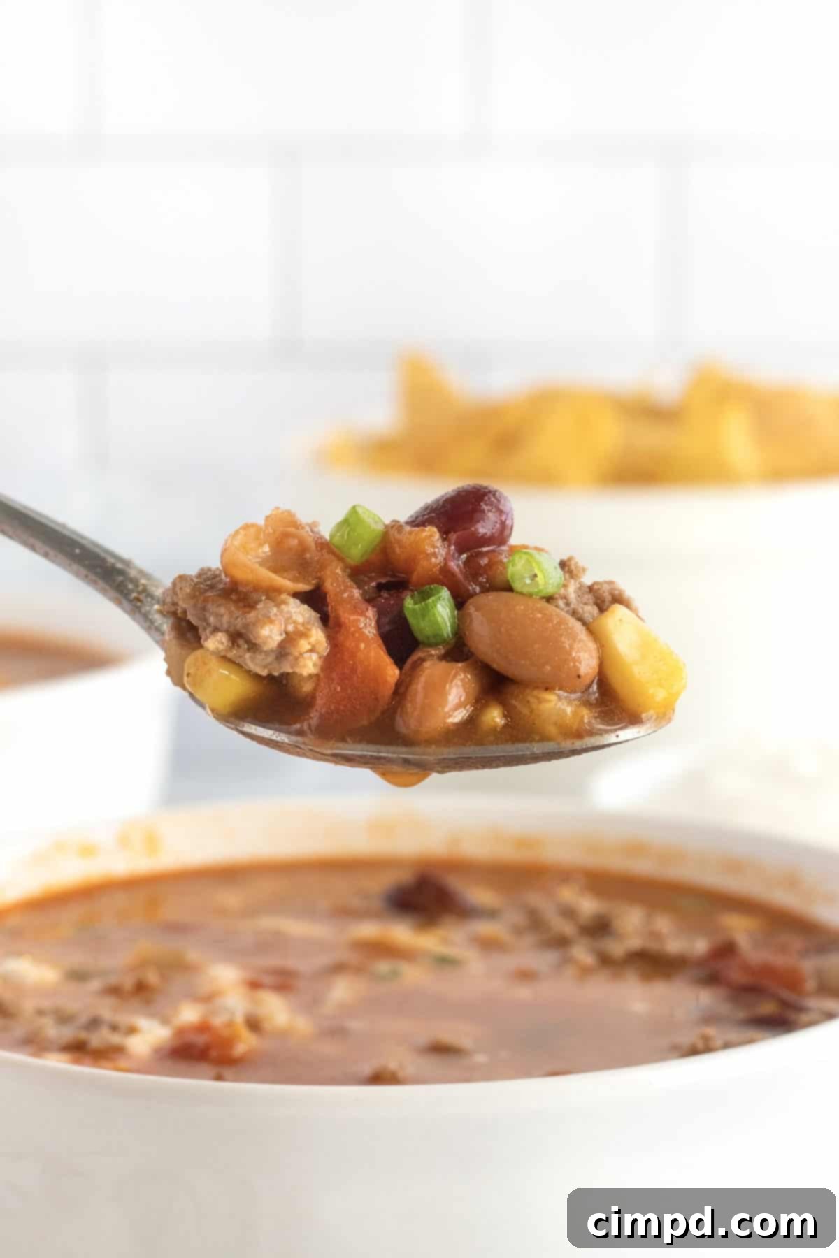 Taco Soup served with fresh toppings including cheese and green onions